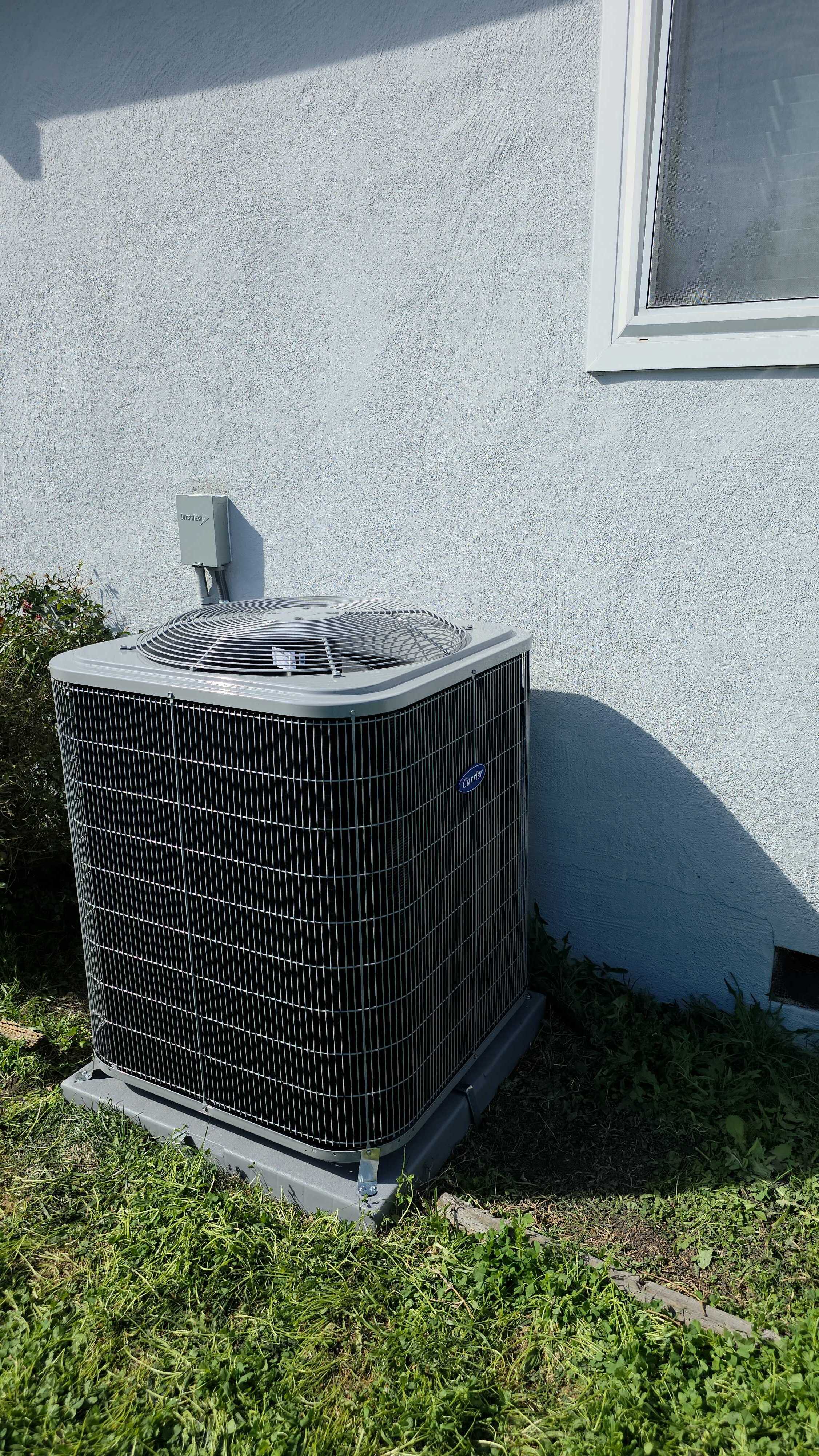 Reliable craftsmanship shown by a neatly installed outdoor condenser, demonstrating Upgrade Home Services' commitment to durable, professional HVAC work.