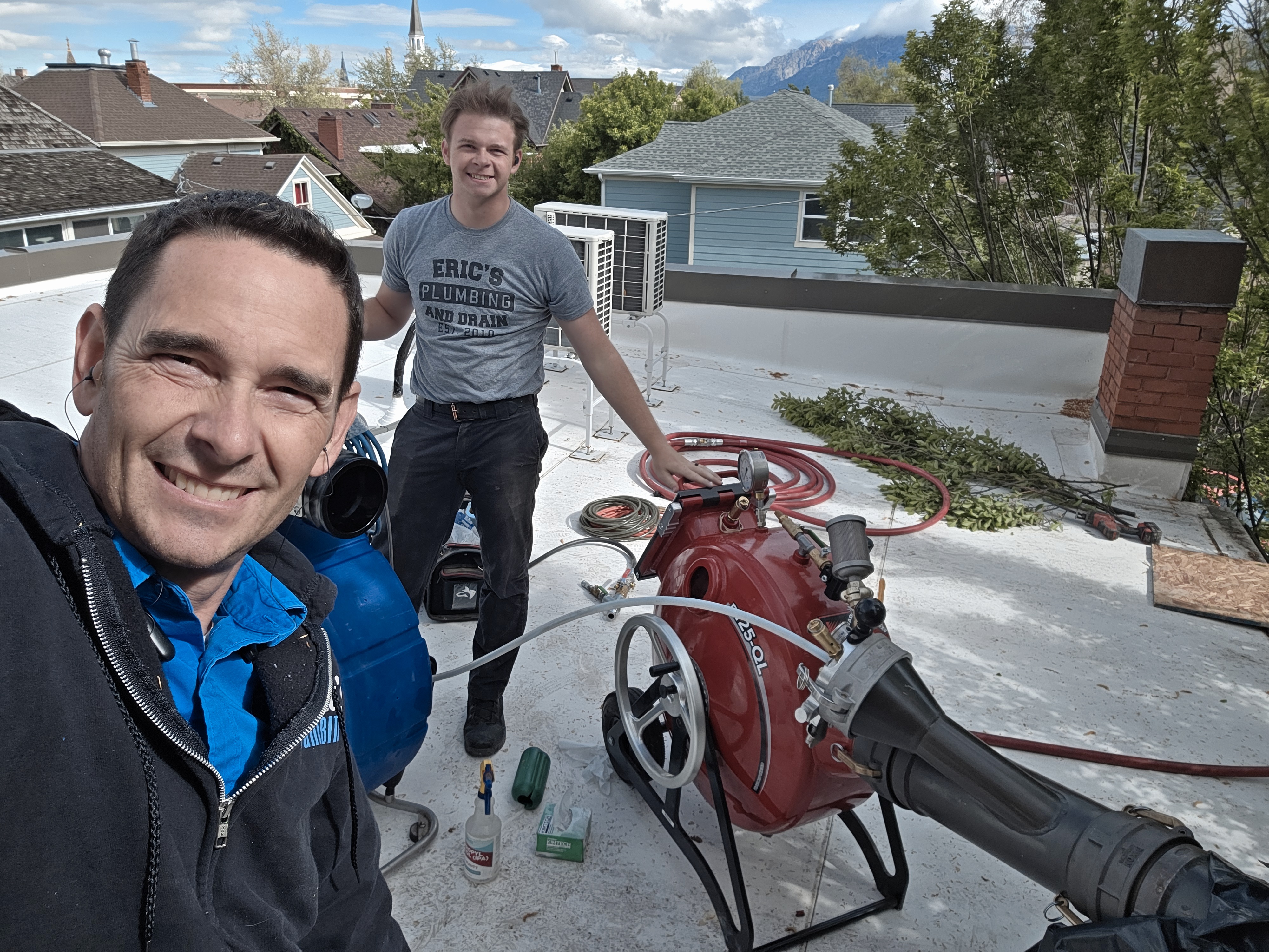 Eric's Plumbing & Drain Cleaning experts at work, delivering top-notch service right on your rooftop!