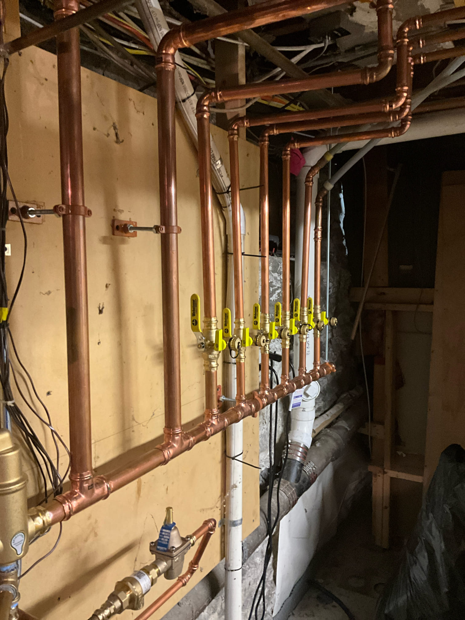 Neat copper piping and organized shutoffs show the dependable workmanship Akian Plumbing, Heating, Cooling & Electric delivers for lasting results.