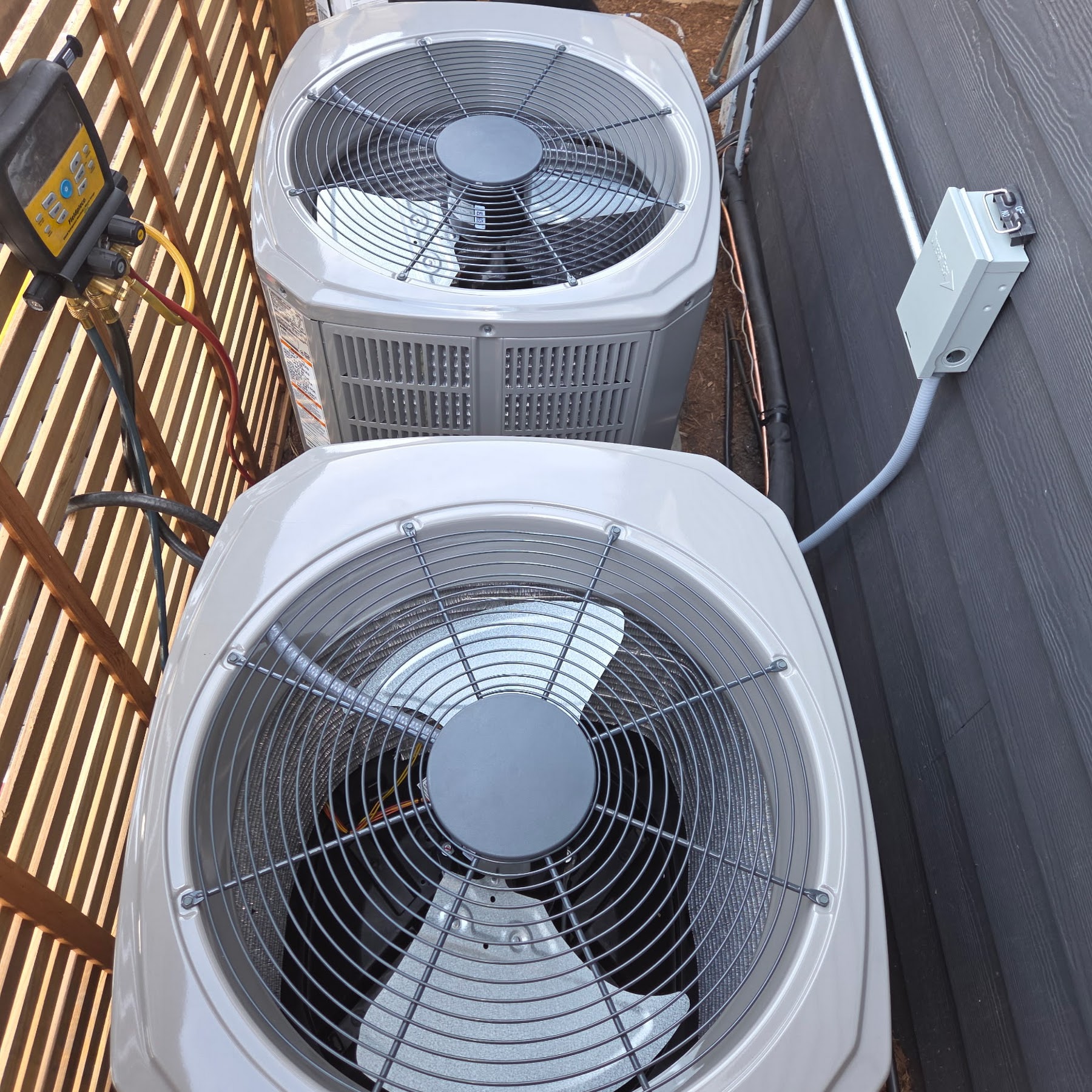 Clean, professionally installed outdoor AC units show the craftsmanship and reliability customers expect from Oasis Heating and Cooling.