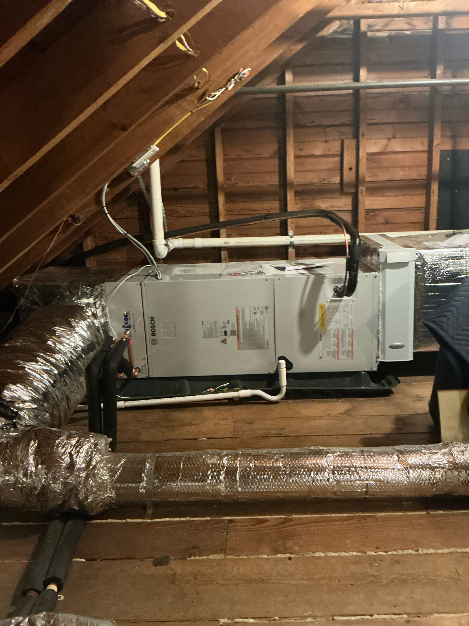 A clean, professionally installed attic air handler shows Akian Plumbing, Heating, Cooling & Electric's commitment to reliable HVAC craftsmanship and efficiency.