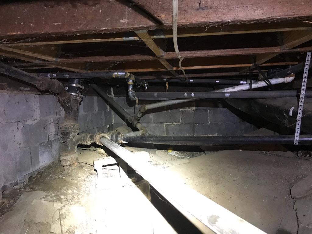 A thorough crawlspace inspection from Shocking Difference LLC reveals aging plumbing and clear repair needs, demonstrating our attention to safety.