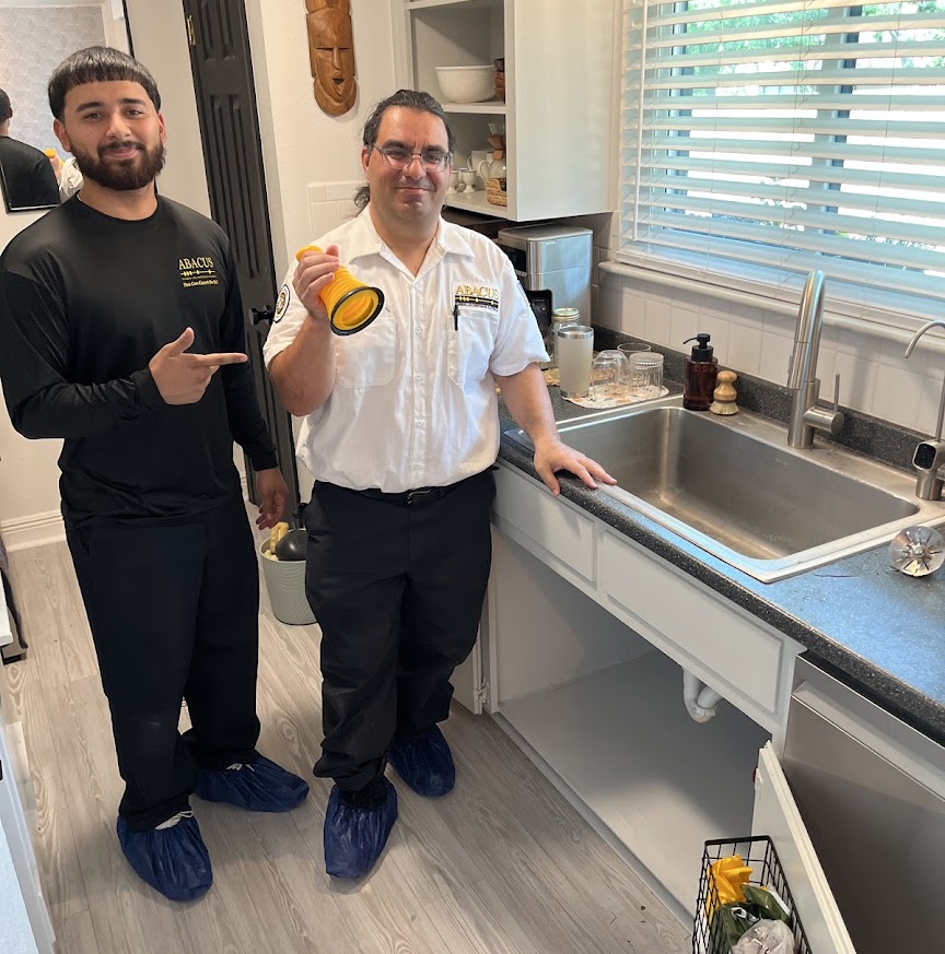 Friendly technicians from Abacus Plumbing, Air Conditioning, & Electrical demonstrate careful, professional plumbing service while protecting your home.