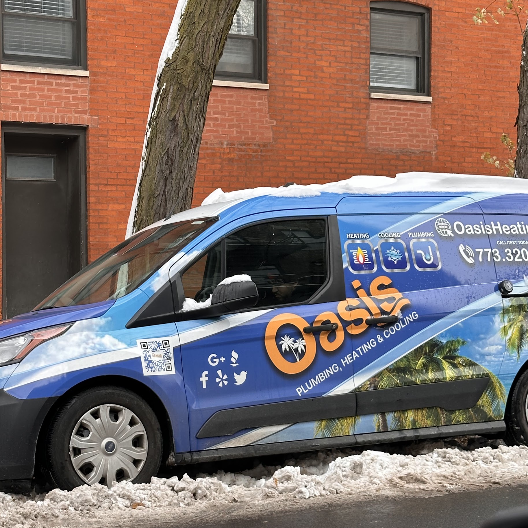 A clean, professionally wrapped service van parked in a winter setting shows Oasis Heating and Cooling ready and reliable for fast, local service.