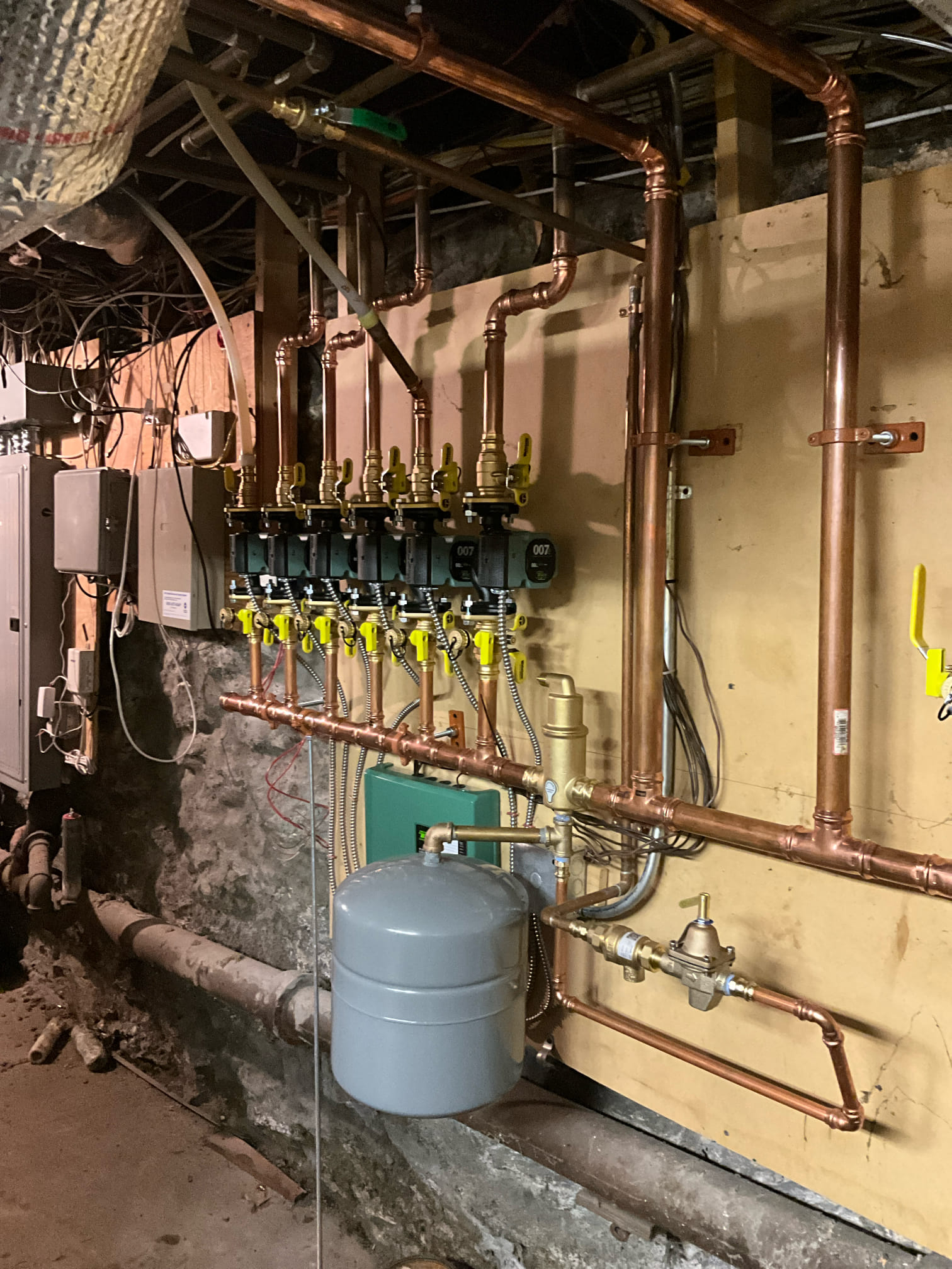Experienced technicians from Akian Plumbing, Heating, Cooling & Electric installed this tidy, durable copper manifold system to improve reliability and control.
