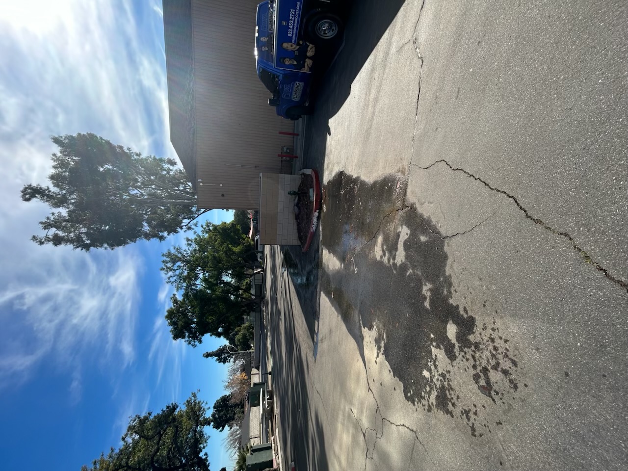 A Cruz Plumbing & Rooter Services truck on site shows quick, professional response to a recent water issue in the parking area.