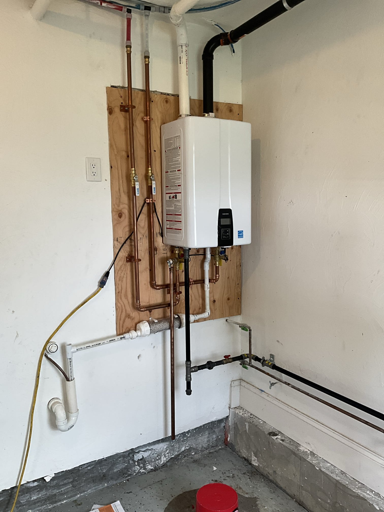 A clean, professional tankless water heater installation shows the reliable craftsmanship customers expect from Akian Plumbing, Heating, Cooling & Electric.