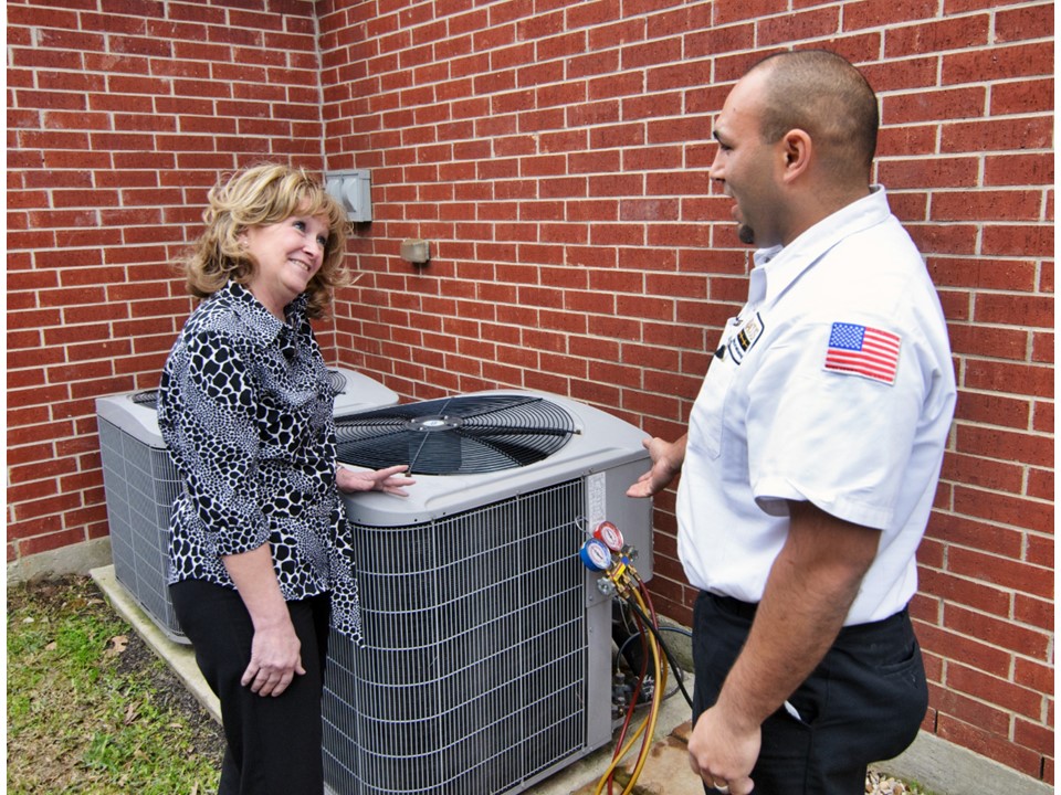 A friendly service visit shows Abacus Plumbing, Air Conditioning & Electrical delivering professional HVAC maintenance with clear care and attention.