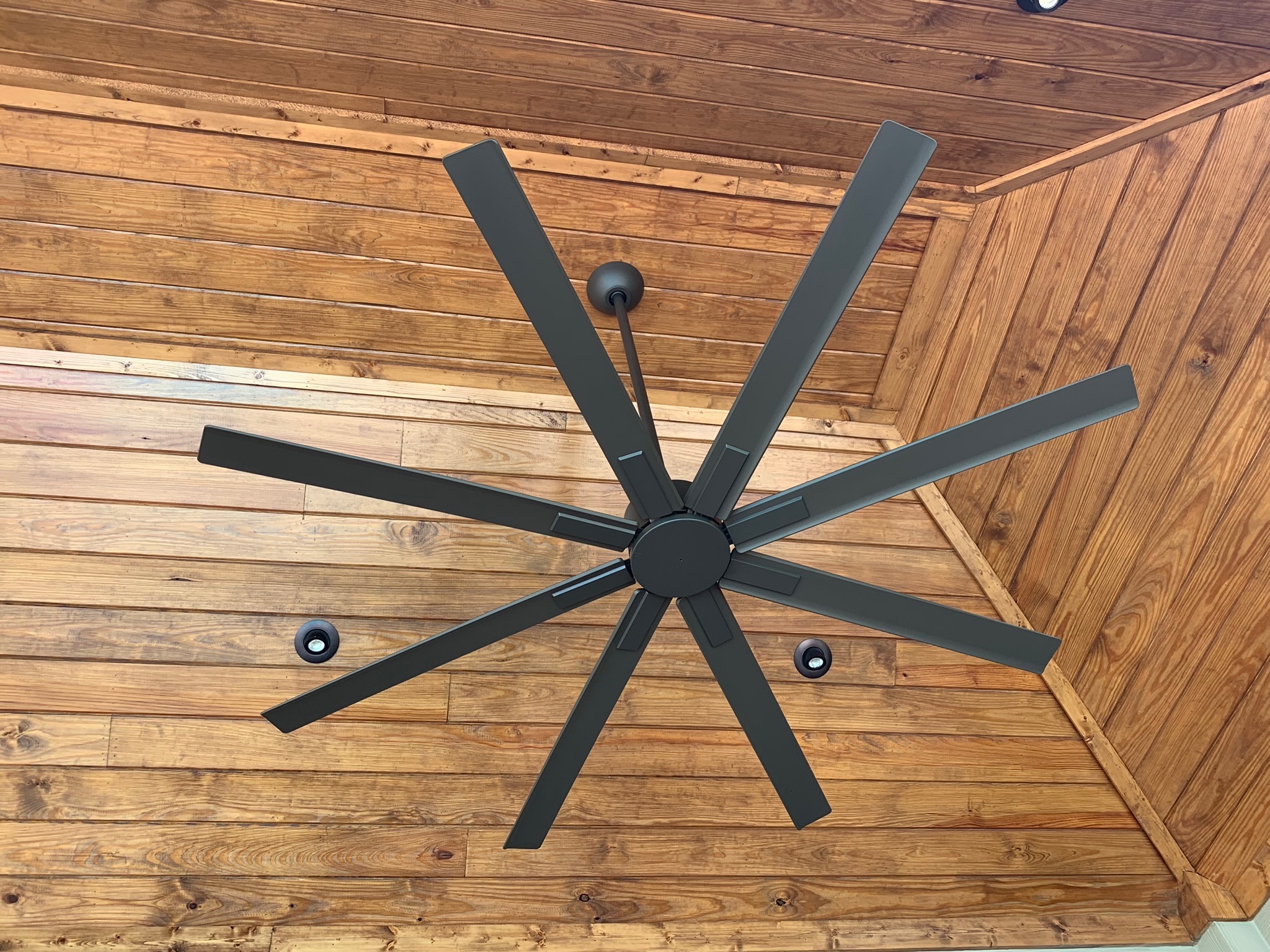 A clean, professionally installed oversized ceiling fan adds comfort and lasting value to outdoor living spaces, courtesy of West Houston Electric, Inc.