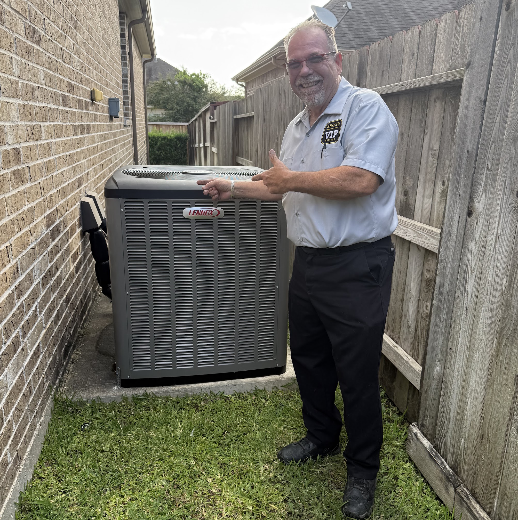 Standing proudly beside a newly installed Lennox unit, Abacus Plumbing, Air Conditioning & Electrical showcases dependable workmanship and friendly service.