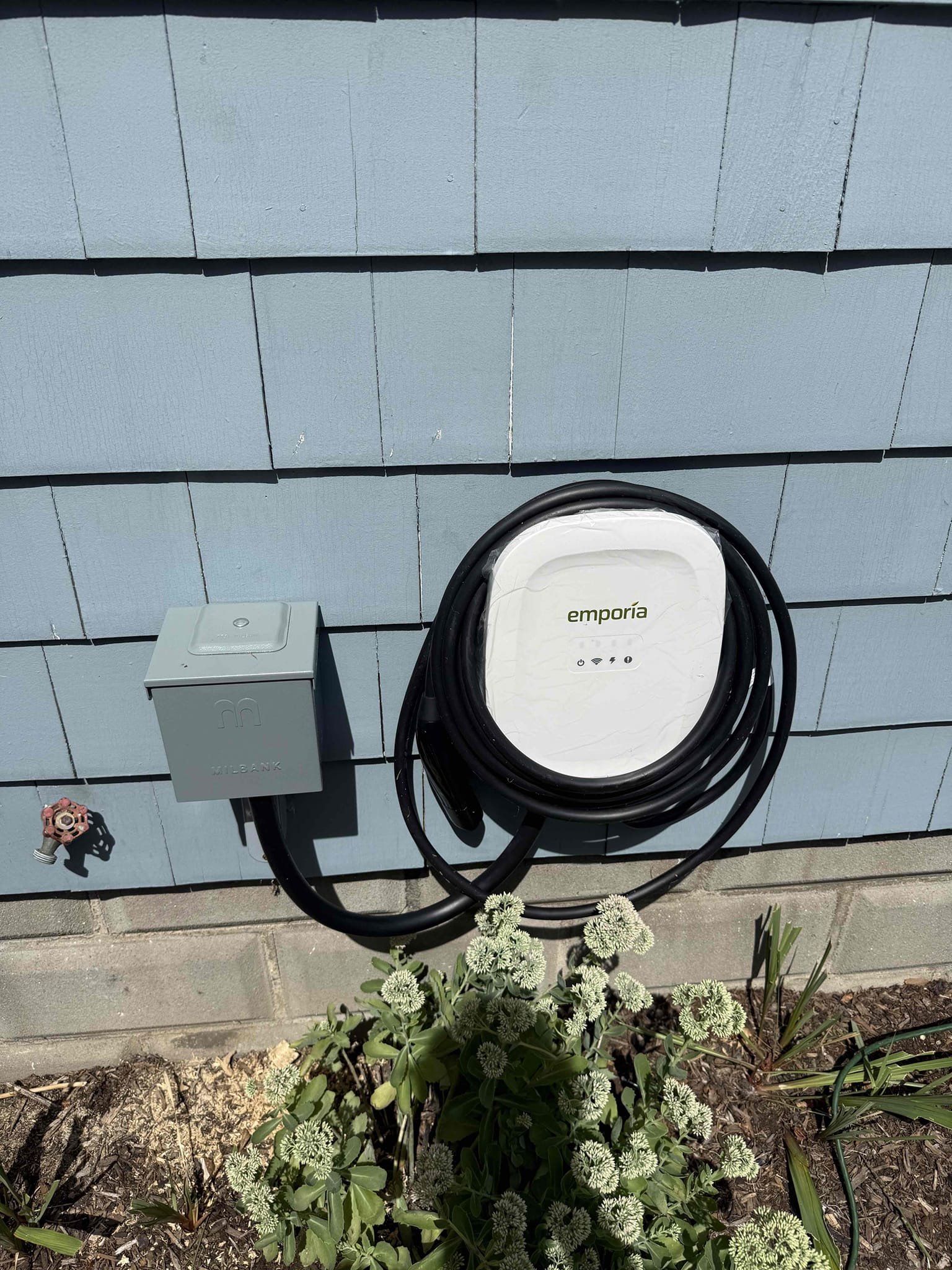 Dependable residential electrical upgrades from Akian Plumbing, Heating, Cooling & Electric, shown by a neat Emporia EV charger installation that boosts home convenience.