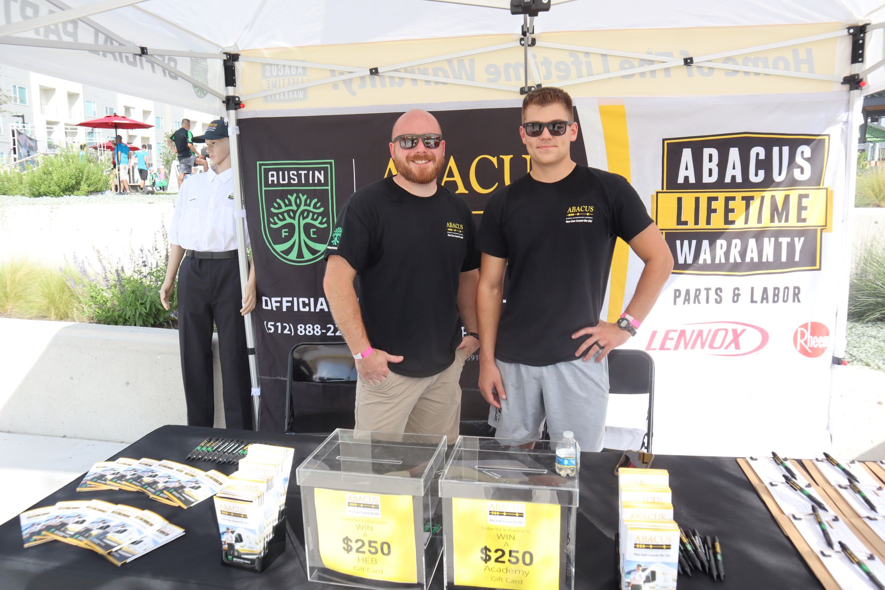 Friendly, professional staff from Abacus Plumbing, Air Conditioning, & Electrical showcase their lifetime warranty and community support at a local event.