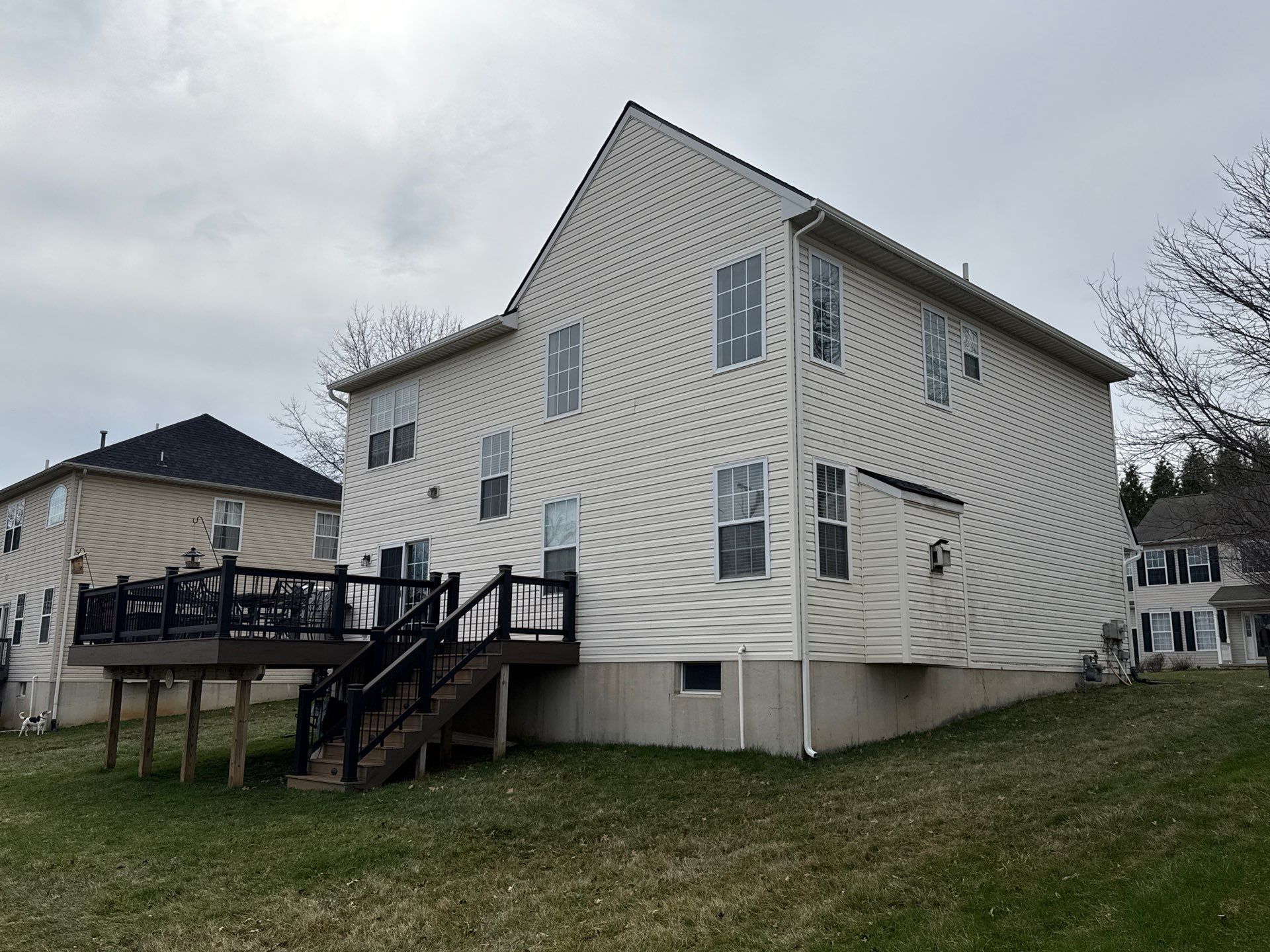 Showcasing durable exterior siding and a sturdy backyard deck, Mosaic Roofing & Exteriors delivers reliable curb appeal and lasting results.