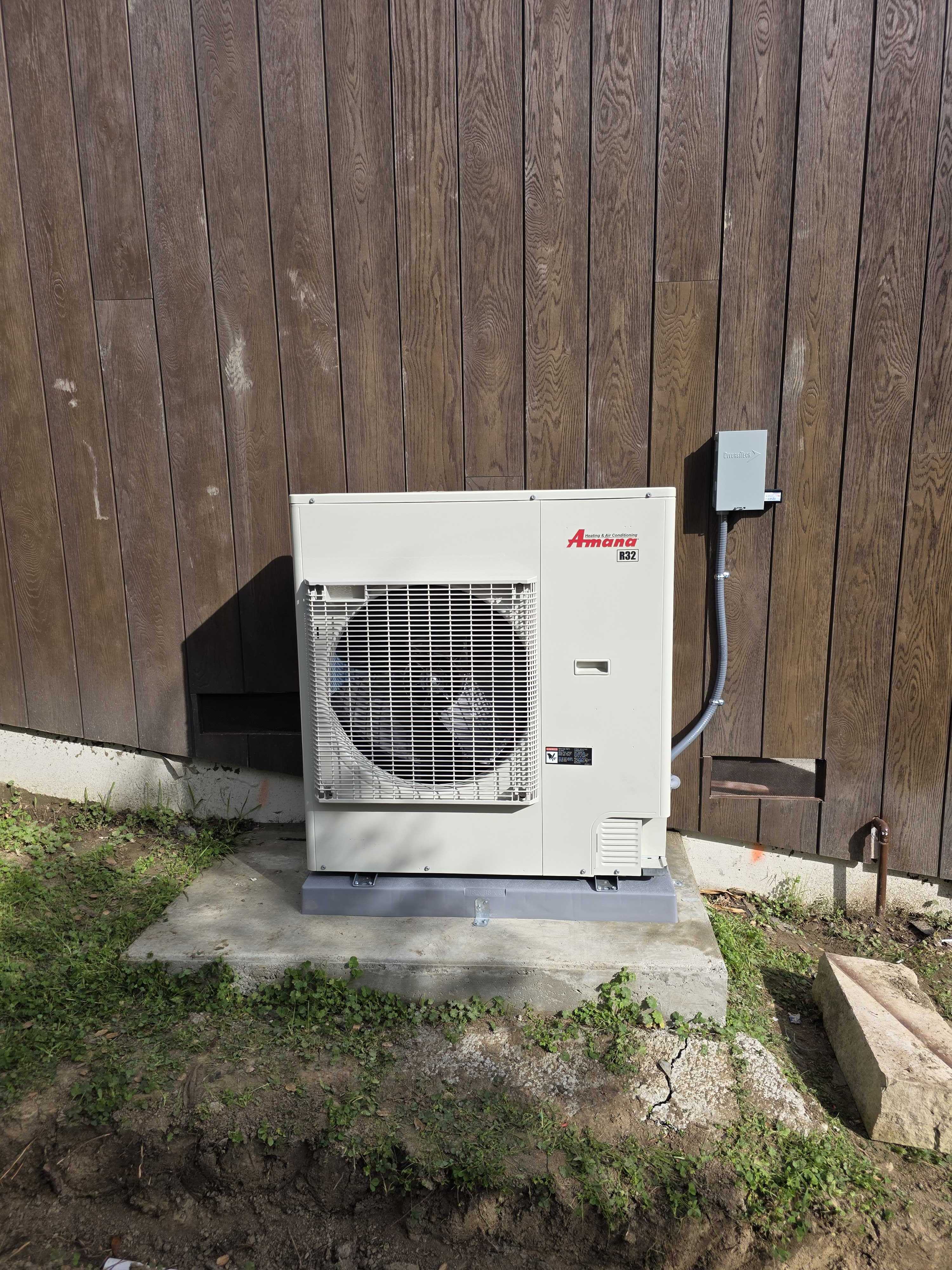 Upgrade Home Services installed this outdoor Amana HVAC unit on a stable concrete pad to ensure reliable, professional cooling performance.