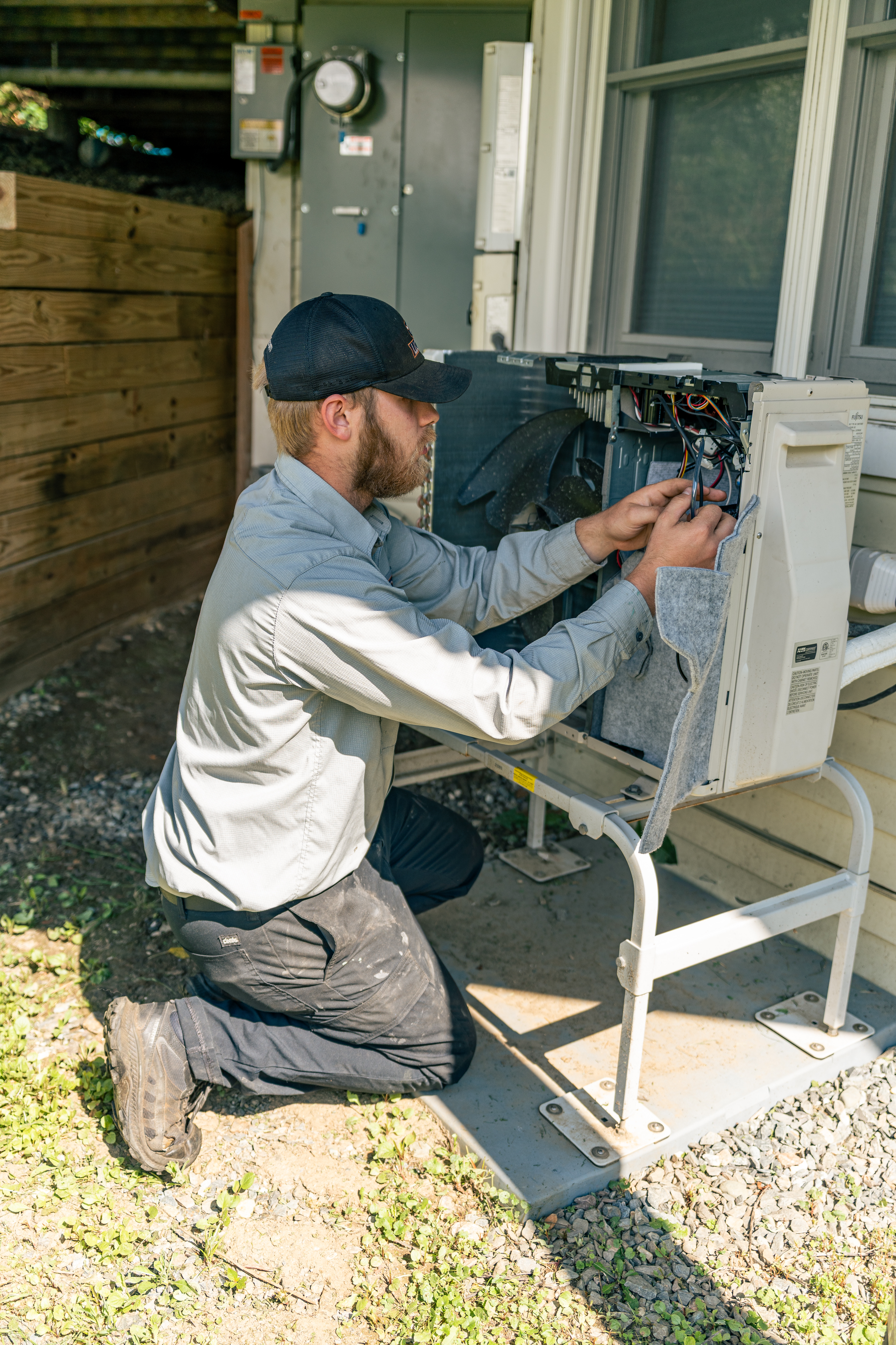 A skilled technician from Lloyd Plumbing, Heating, Air, Electrical performs careful outdoor HVAC repairs to restore comfort and reliability for your home.