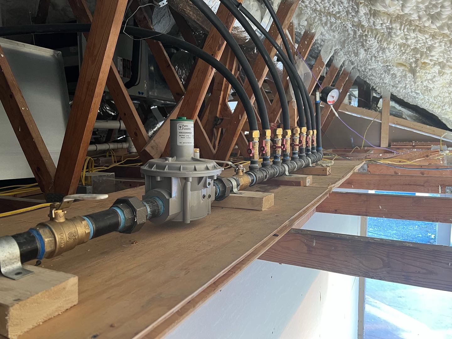 Clean, well-organized attic plumbing with durable components shows Rise Plumbing Systems delivering reliable workmanship and long-term performance.