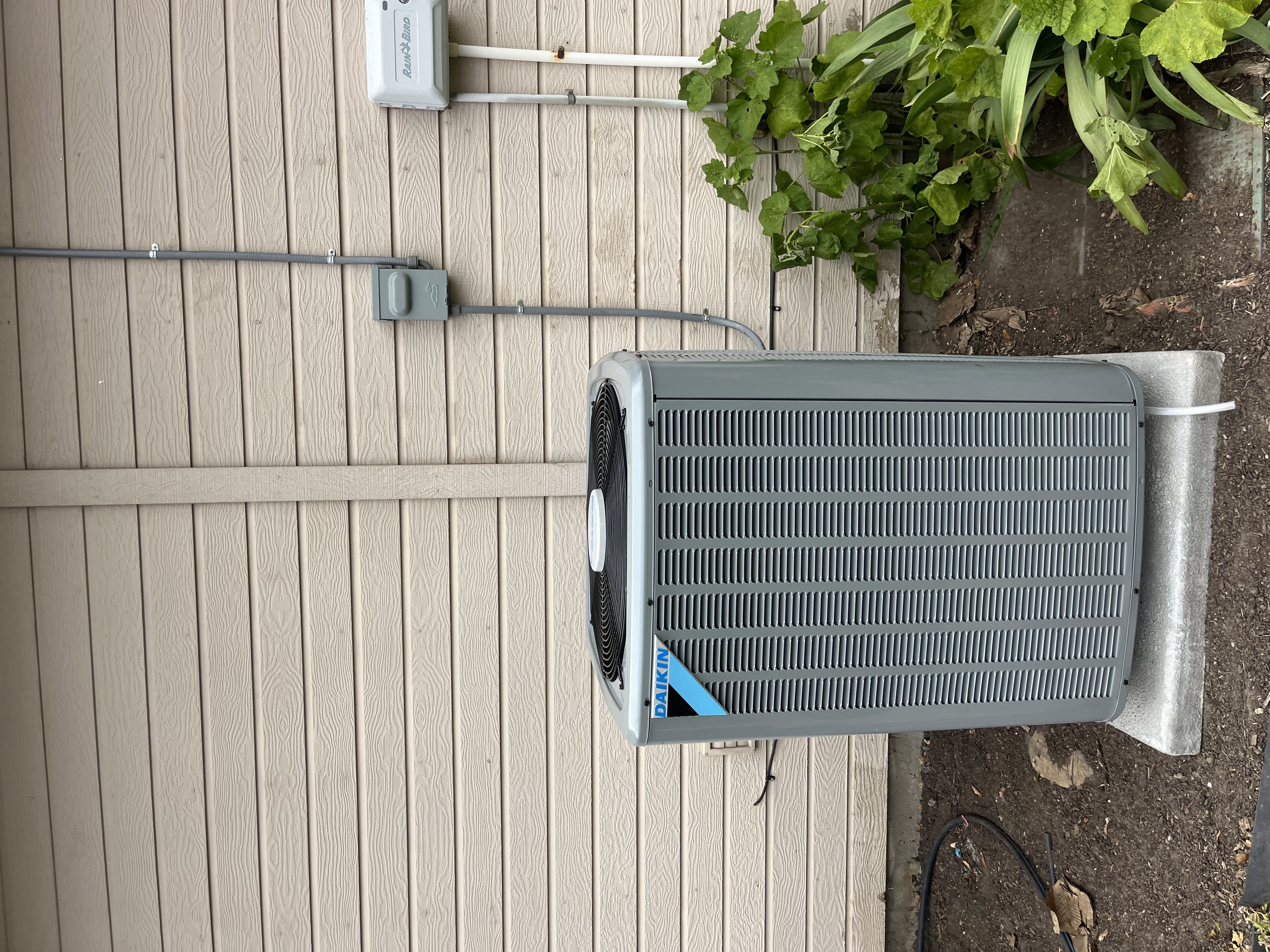 Clean professional installation and reliable cooling from Home Heating & Air Conditioning, mounted neatly on a concrete pad for long lasting performance.