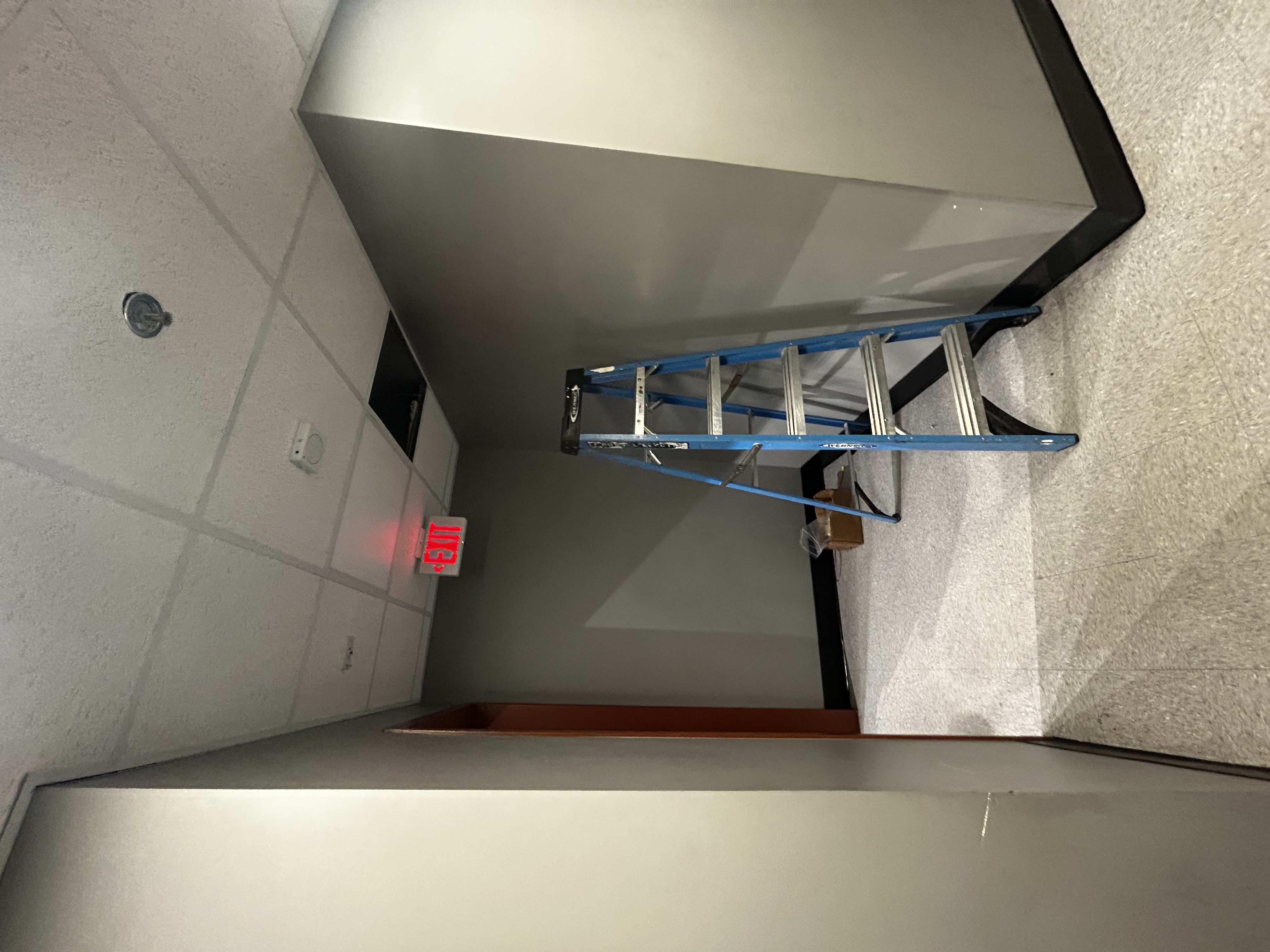Powell Electric demonstrates careful, professional ceiling work with tidy setup and visible safety measures to protect your space.