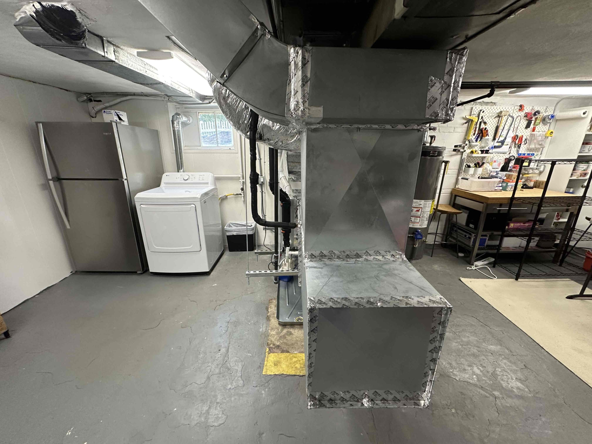Neat, professional ductwork and service in a finished basement highlight how Akian Plumbing, Heating, Cooling & Electric delivers lasting HVAC craftsmanship.