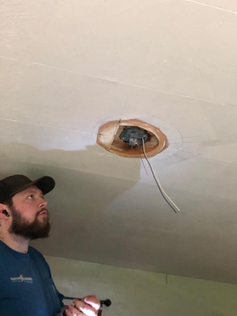 A careful on-site inspection shows how Shocking Difference LLC prioritizes safety and craftsmanship during lighting installations.