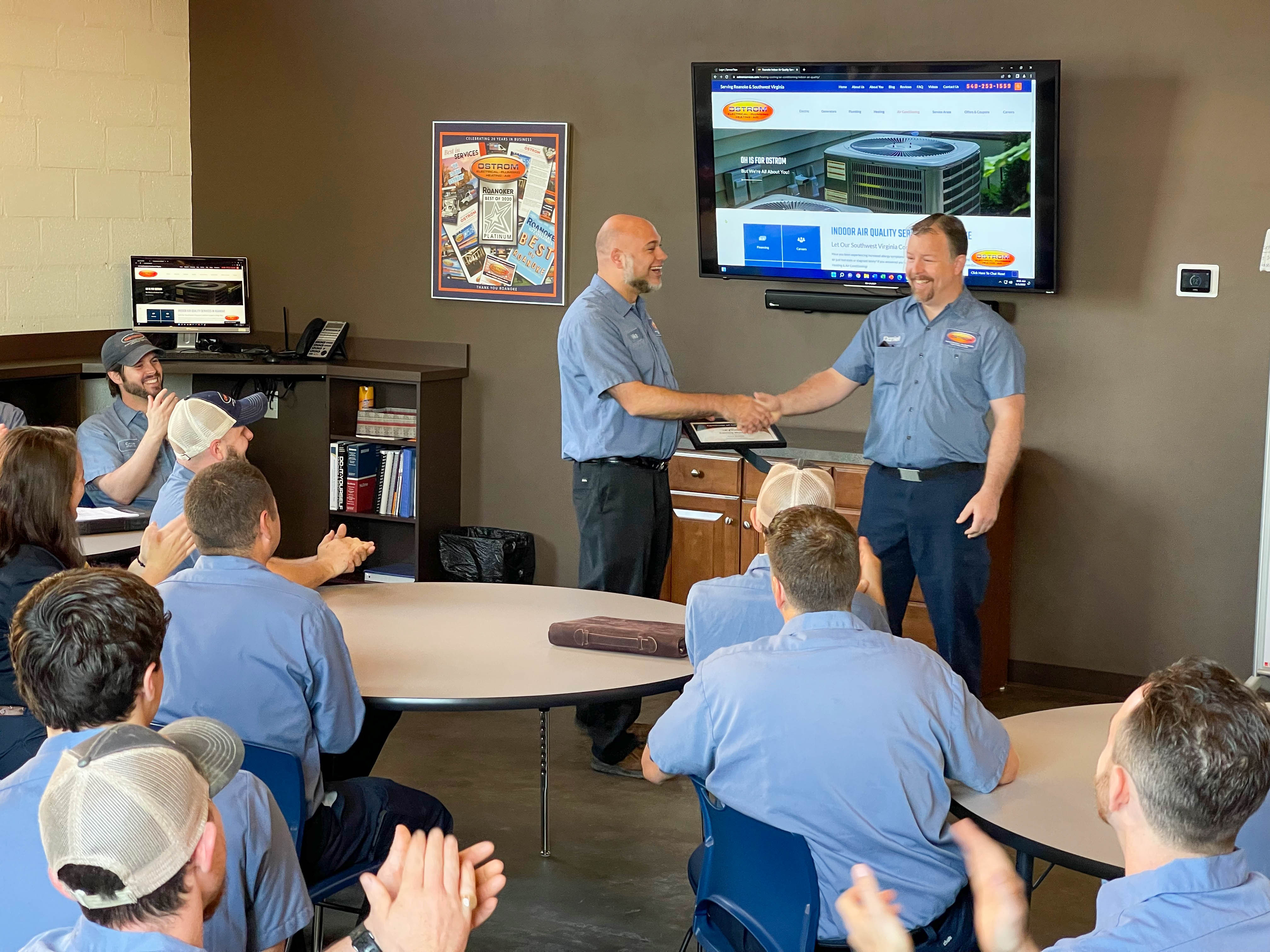Celebrating teamwork and excellence at Ostrom Electrical Plumbing Heating & Air Conditioning, where professionalism and quality service go hand in hand.