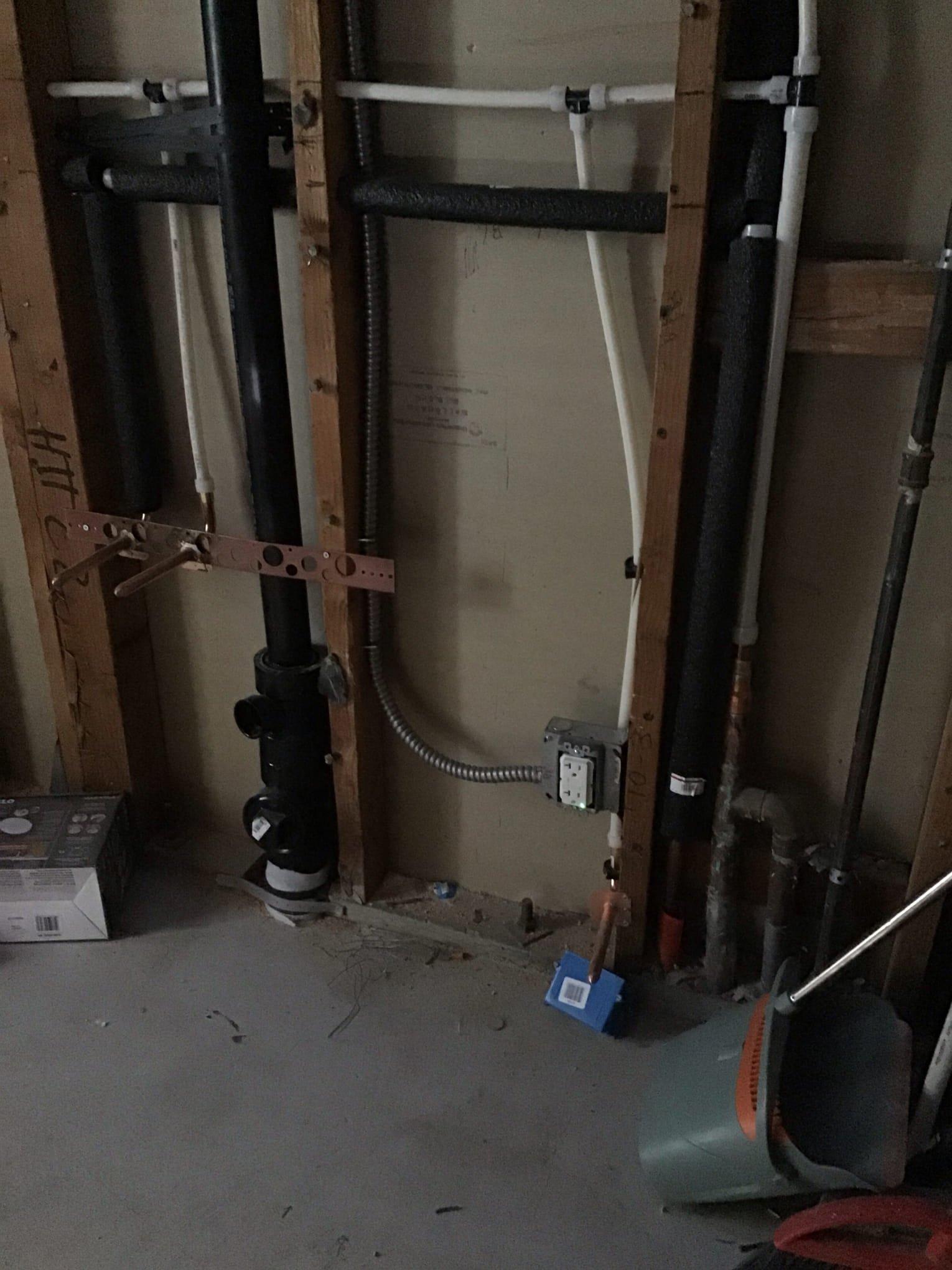 Powell Electric demonstrates careful in-wall electrical and piping coordination to keep installations neat, safe, and code-ready for homeowners.