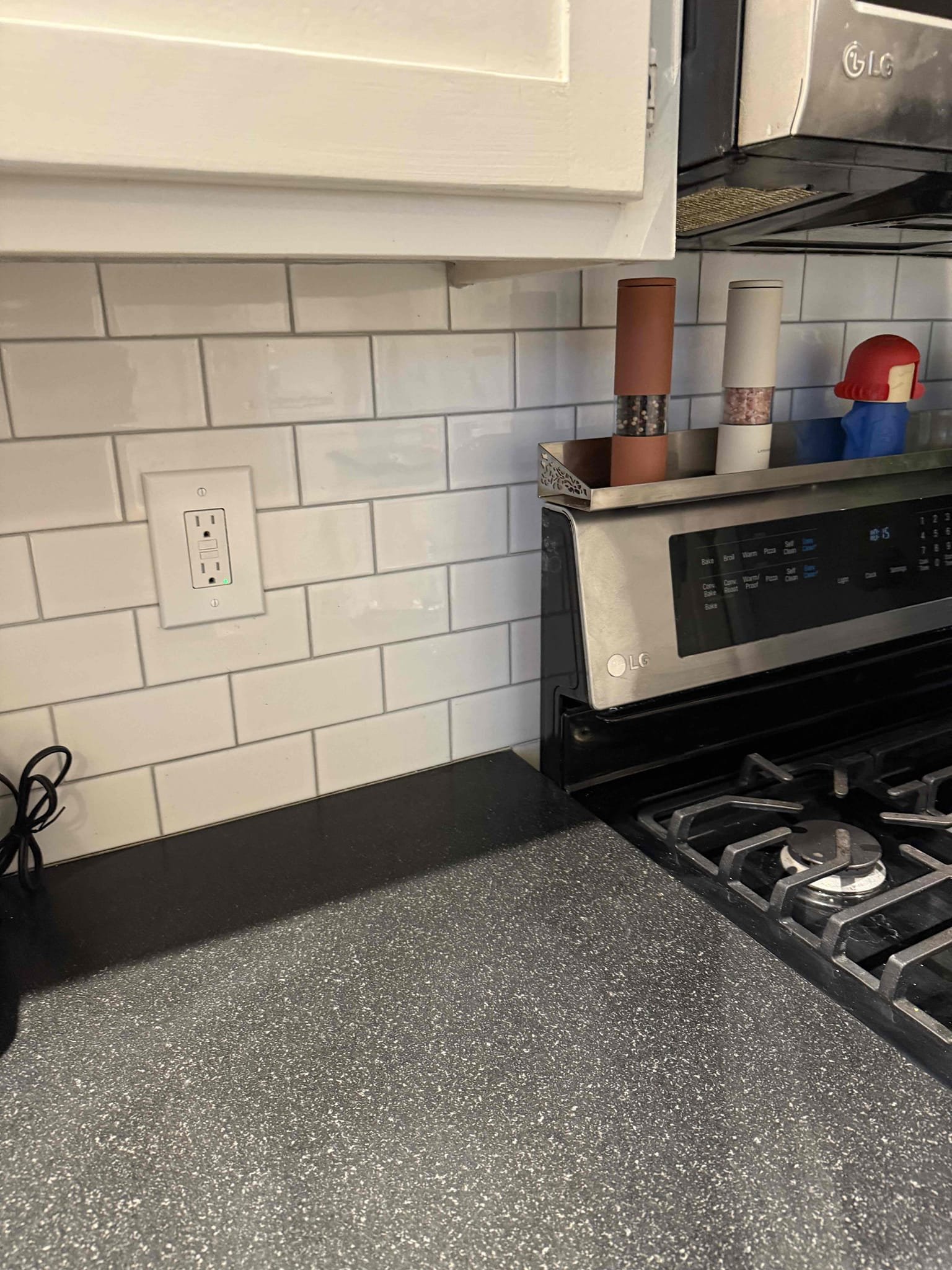 Powell Electric installed a neat, code-compliant GFCI outlet and finished backsplash work that enhances kitchen safety and appearance.