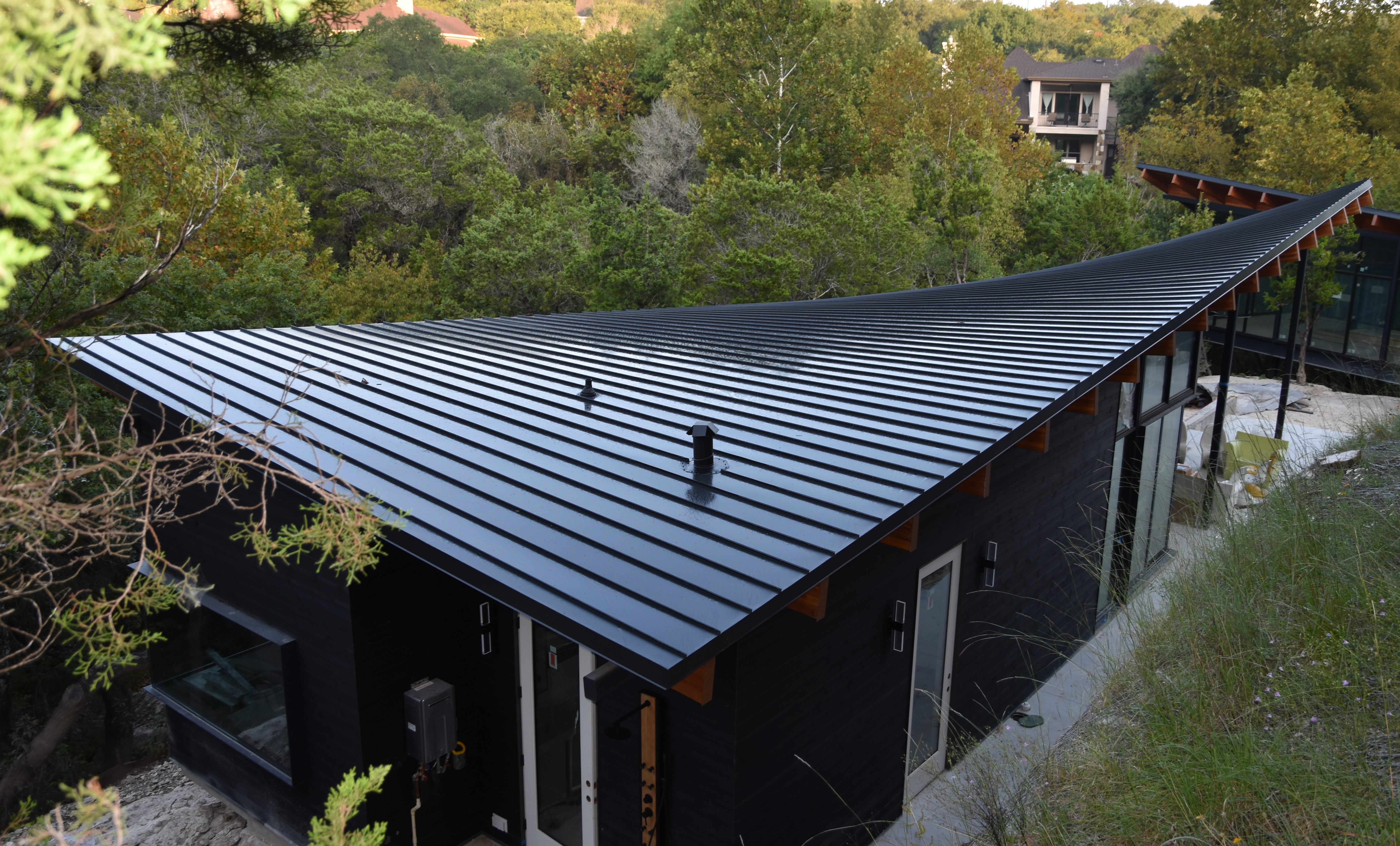 Enhance your building's aesthetics and durability with Green Knight® Metal Roofing, perfectly blending modern design with natural surroundings.