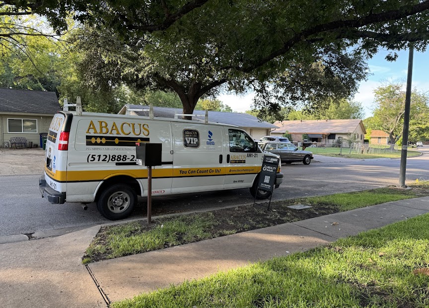 A branded Abacus Plumbing, Air Conditioning, & Electrical service van on-site in the neighborhood, showing dependable, professional local service.