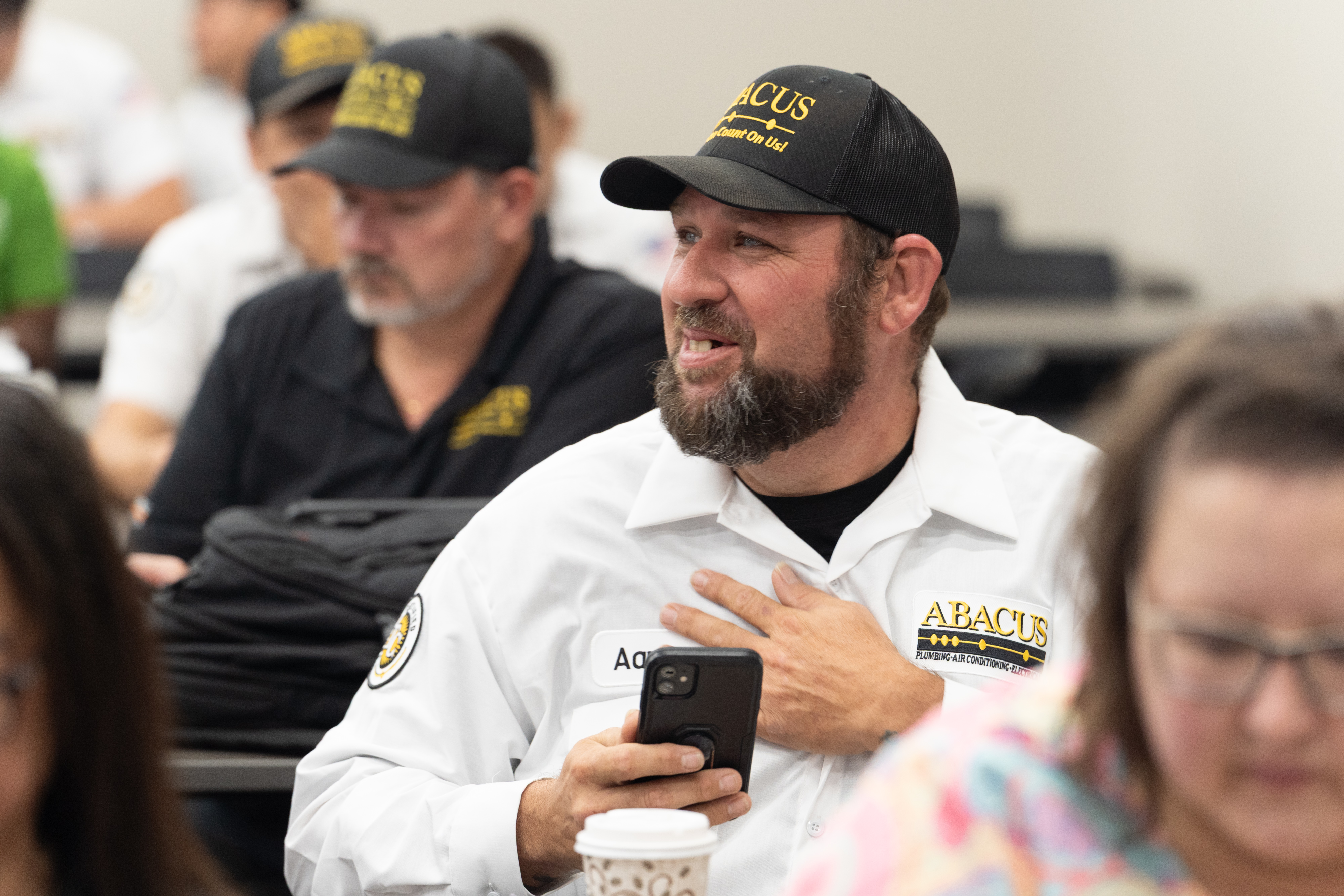 A engaged team member showcases Abacus Plumbing, Air Conditioning, & Electrical’s commitment to professional training and reliable customer service.