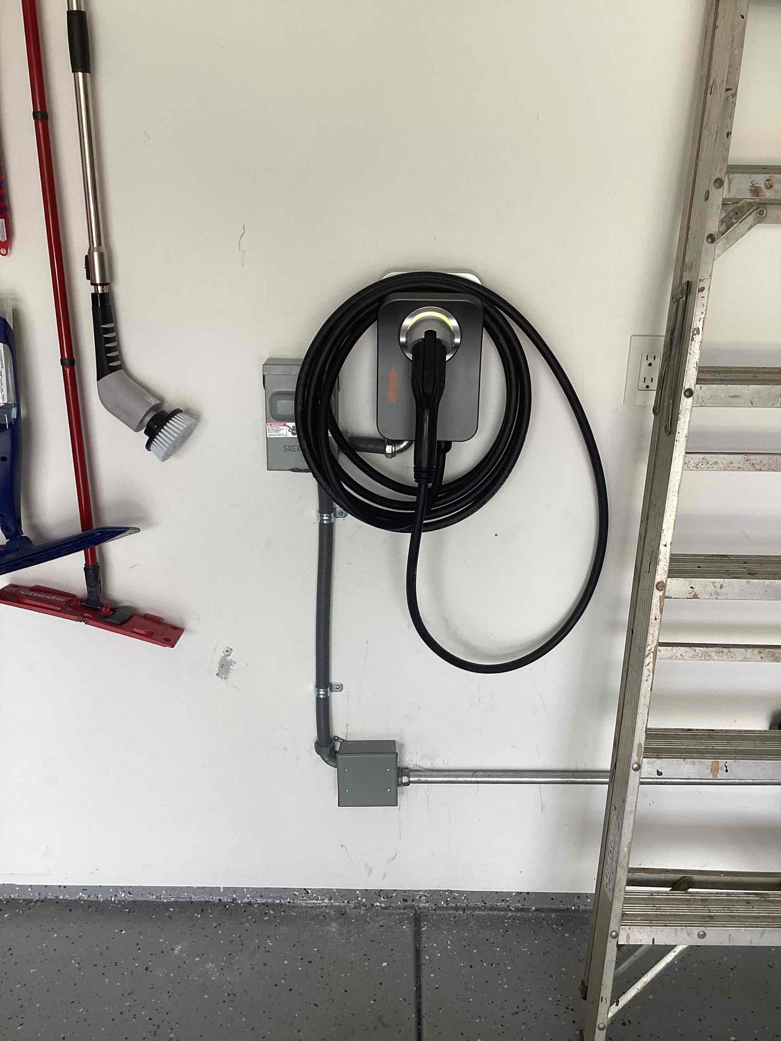 Powell Electric installed a clean, professionally mounted home EV charger with tidy conduit and cable management that boosts safety and convenience.