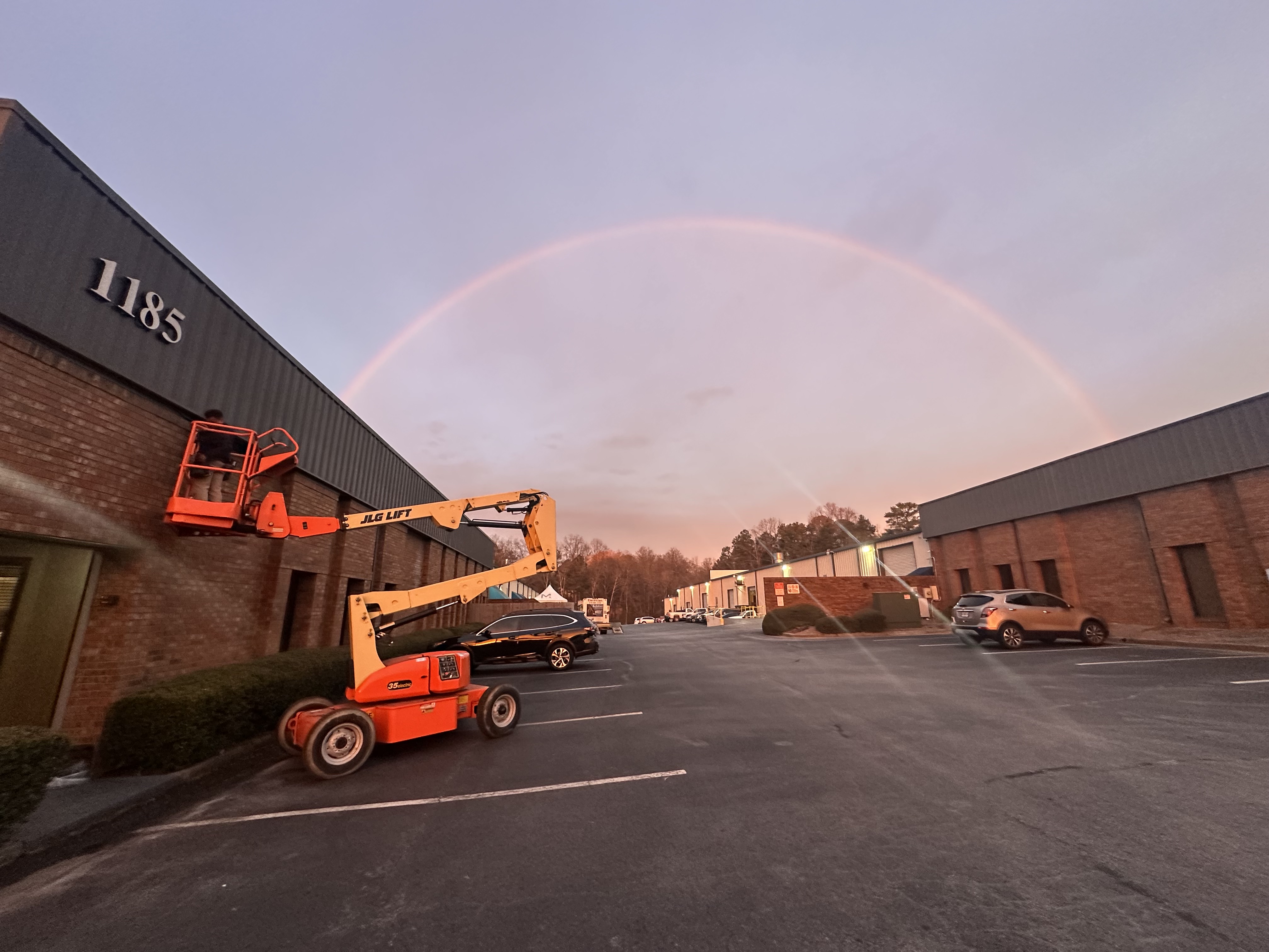 A warm sunset and a full rainbow highlight Kalahari Electrical Services' reliable field presence and safe on-site equipment.