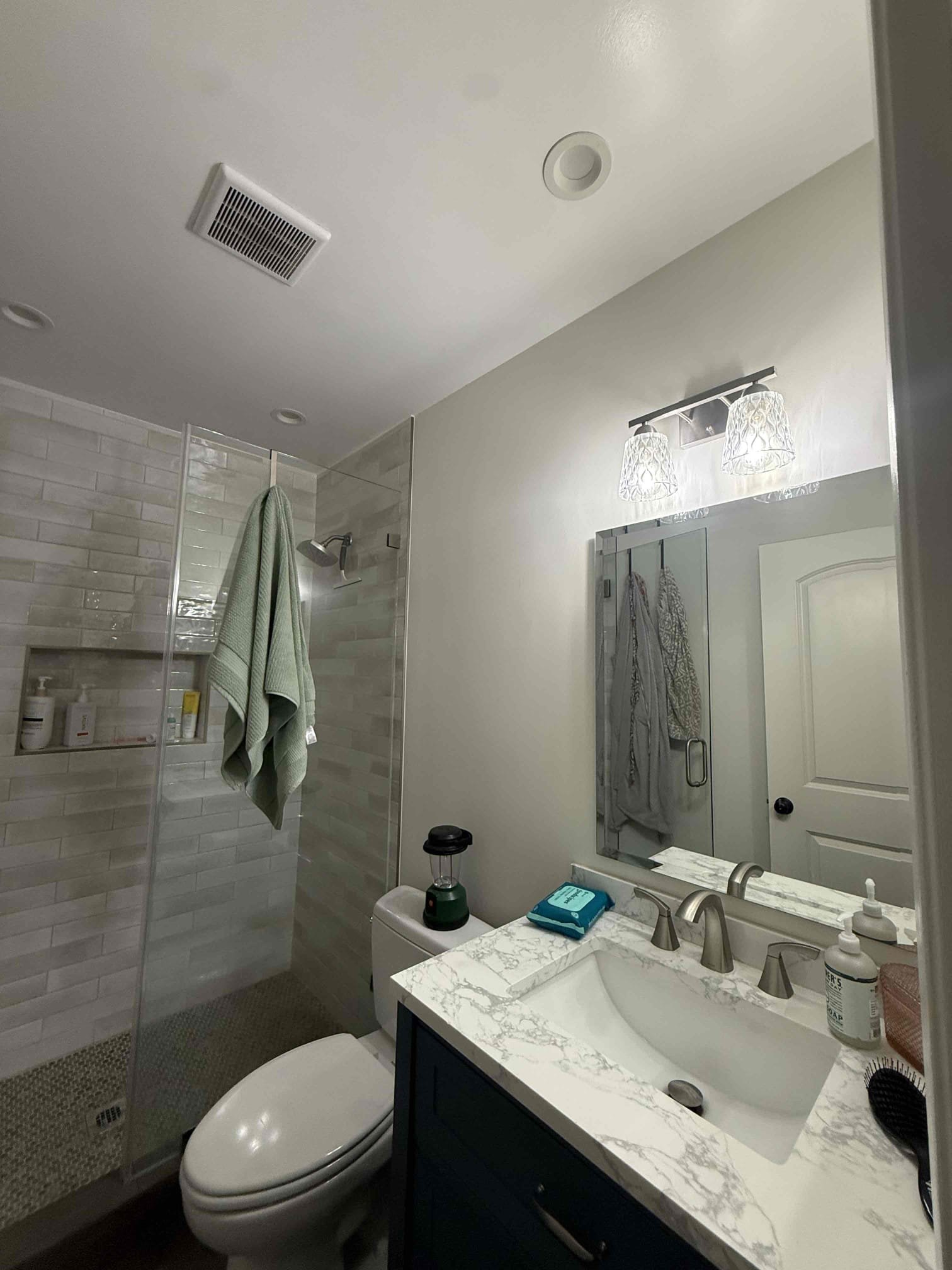 Bright, professionally installed bathroom lighting and ventilation highlight Powell Electric's attention to safe, clean workmanship.