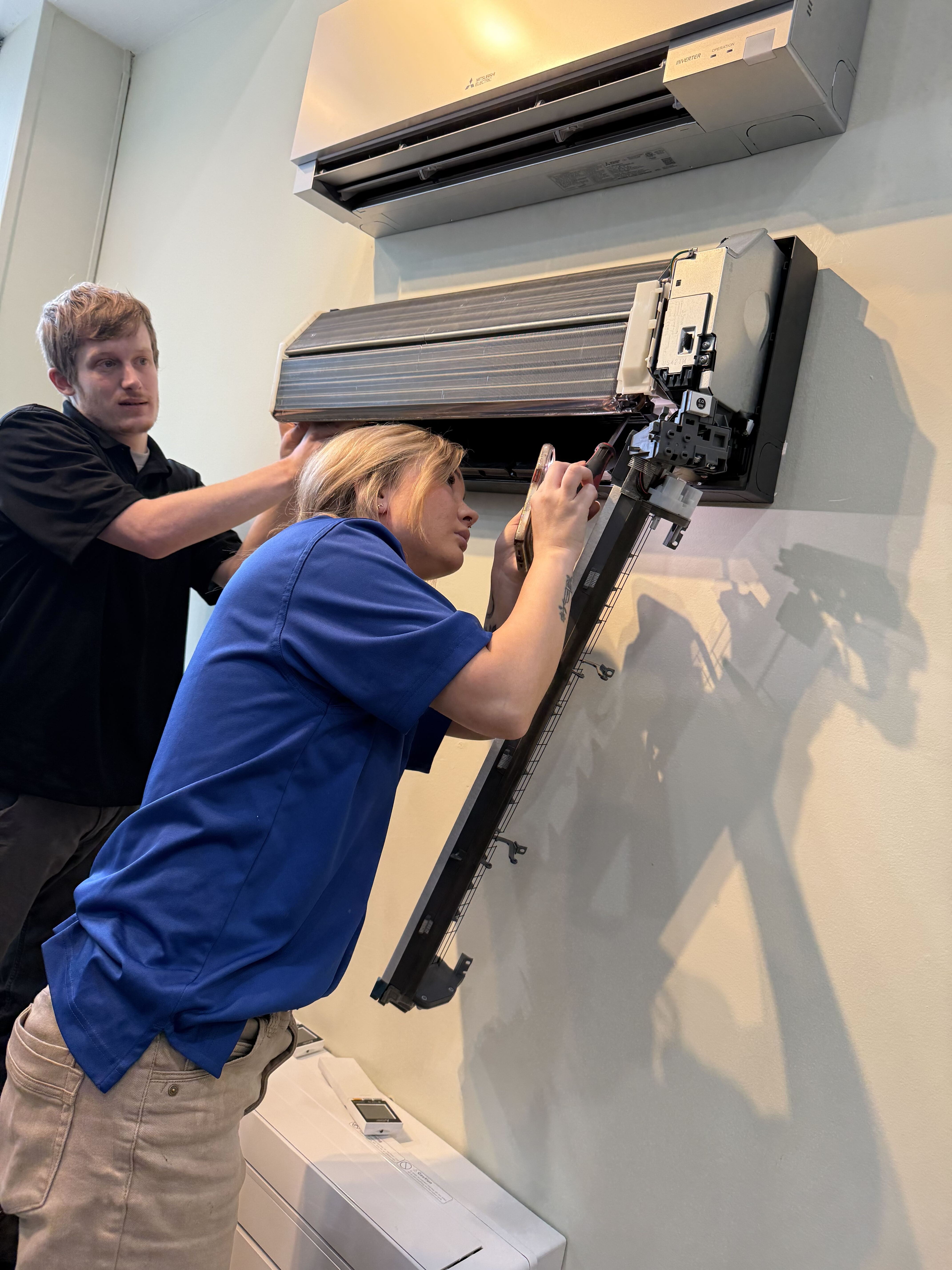 Skilled technicians carefully service a ductless mini-split to ensure reliable comfort and lasting performance from Akian Plumbing, Heating, Cooling & Electric.