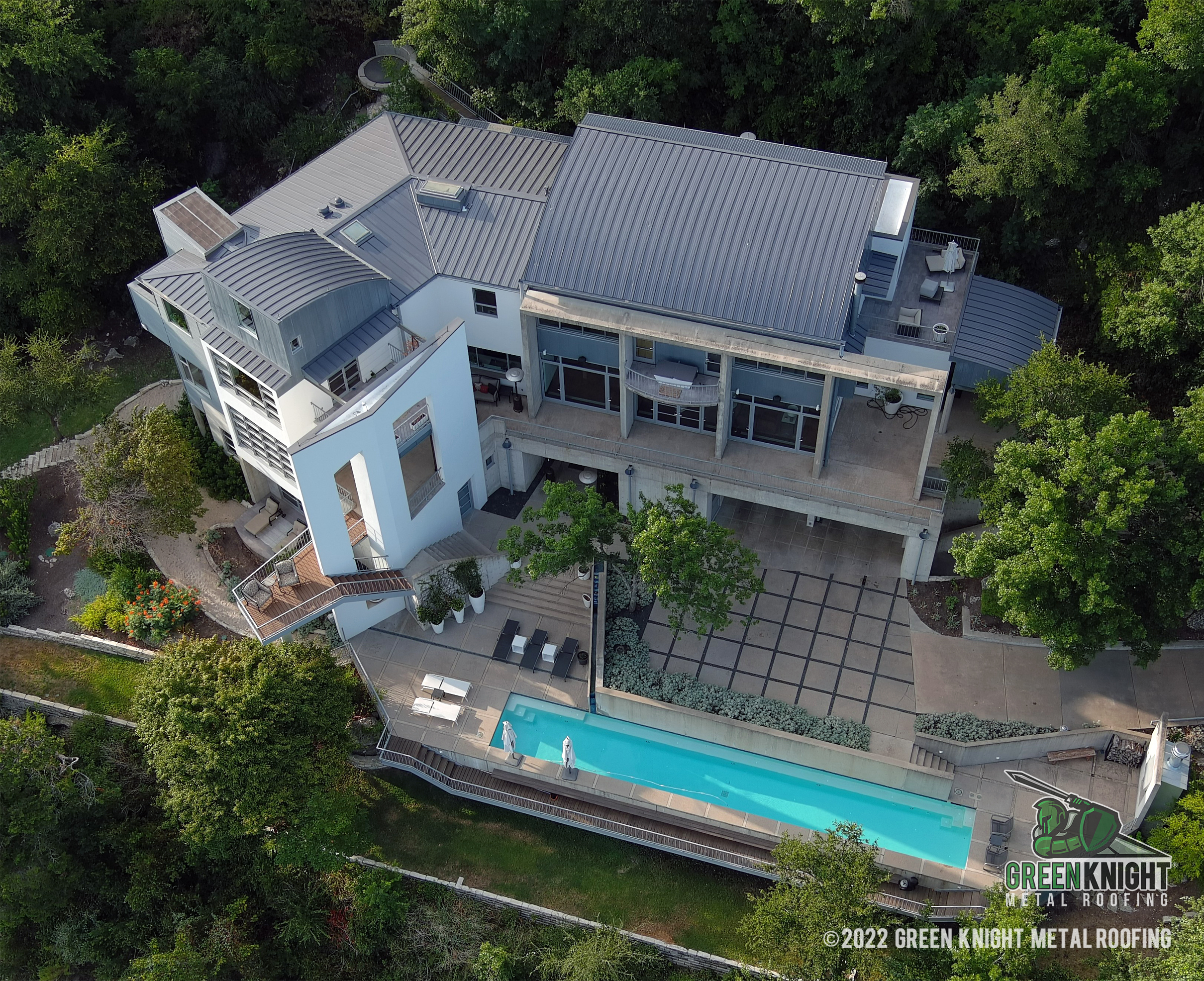 Green Knight® Metal Roofing beautifully exemplifies precision and style in this modern home, providing an elegant and durable roofing solution that enhances the natural landscape.
