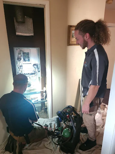 AccuTemp Heating & Air Conditioning technicians carefully service home HVAC equipment, protecting floors and delivering dependable workmanship.