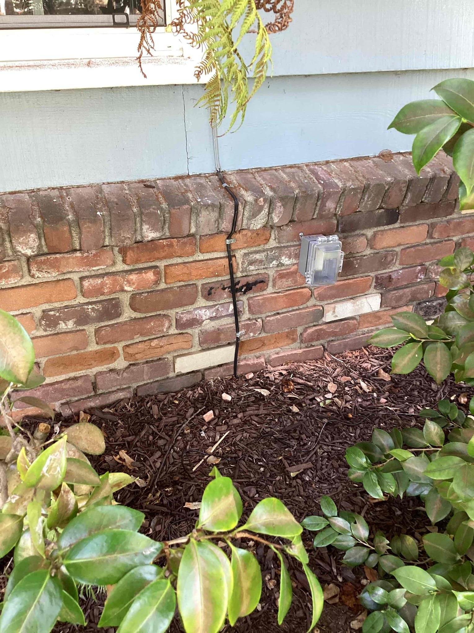 Powell Electric shows professional exterior installations with weatherproof outlets and tidy landscaping to protect outdoor connections.