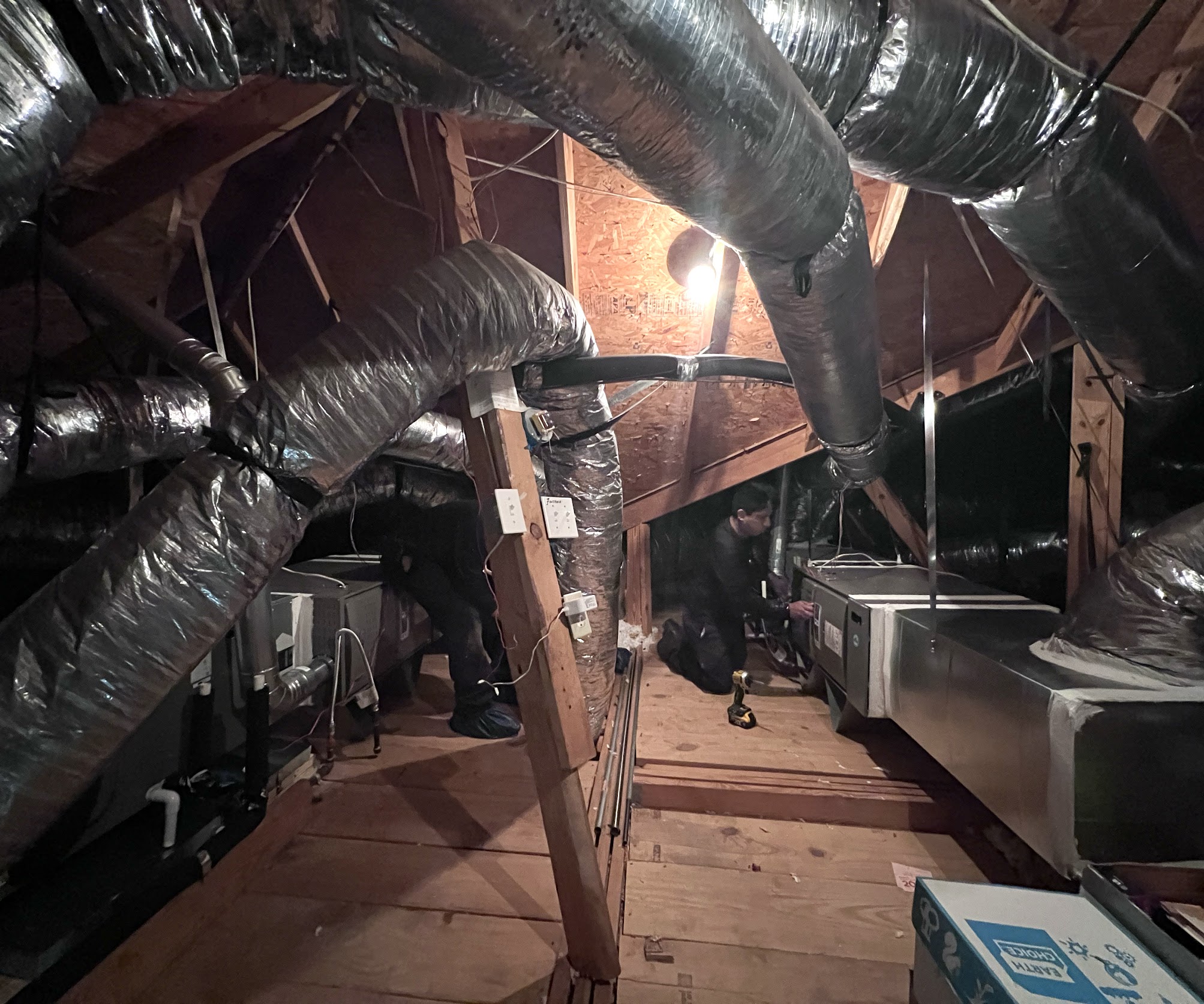 Skilled technicians complete careful attic HVAC work to improve home comfort, showcasing Abacus Plumbing, Air Conditioning & Electrical's reliable service.