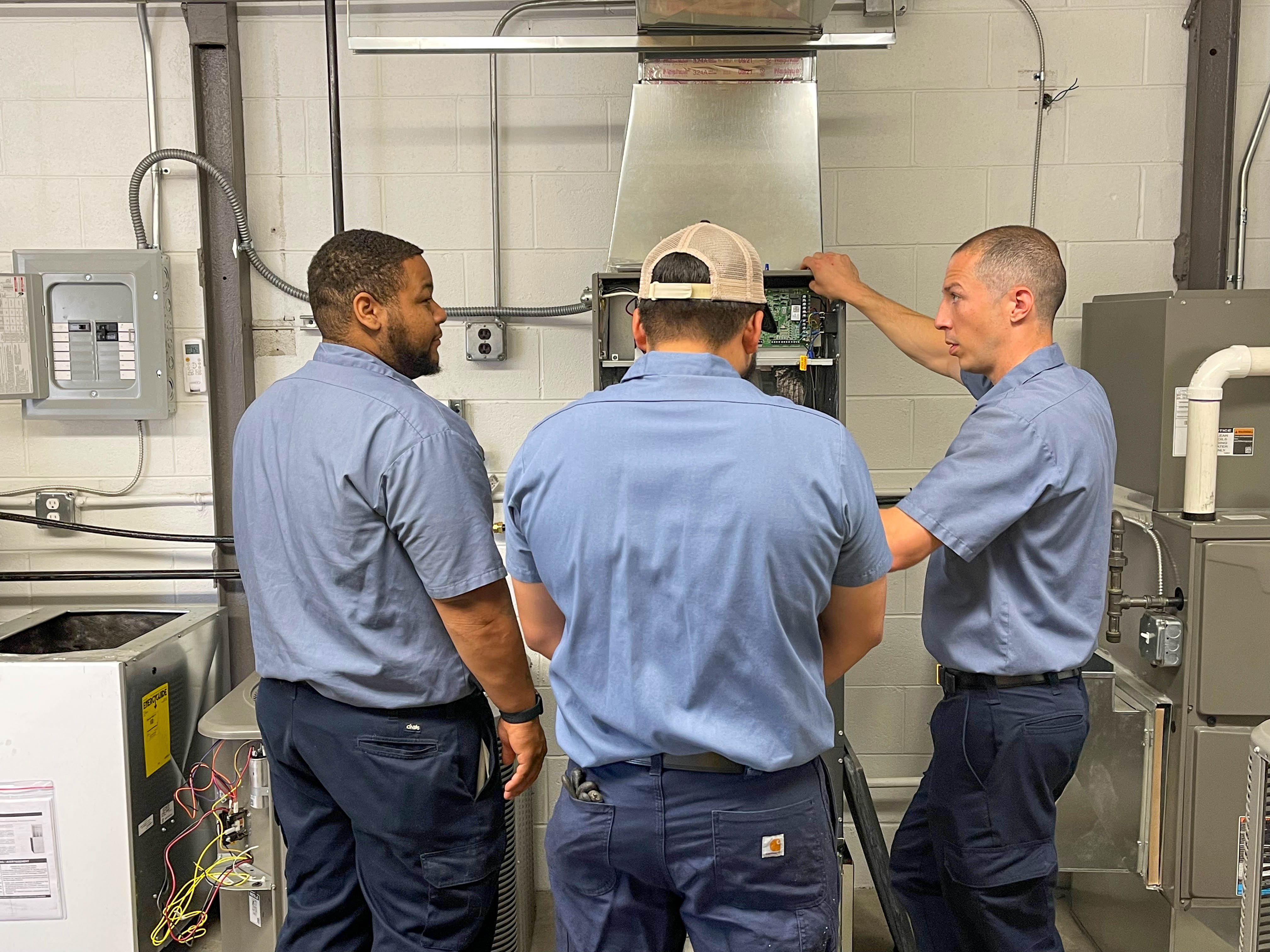 Expert technicians from Ostrom Electrical Plumbing Heating & Air Conditioning ensure top-notch HVAC services through meticulous attention to detail and professional teamwork.