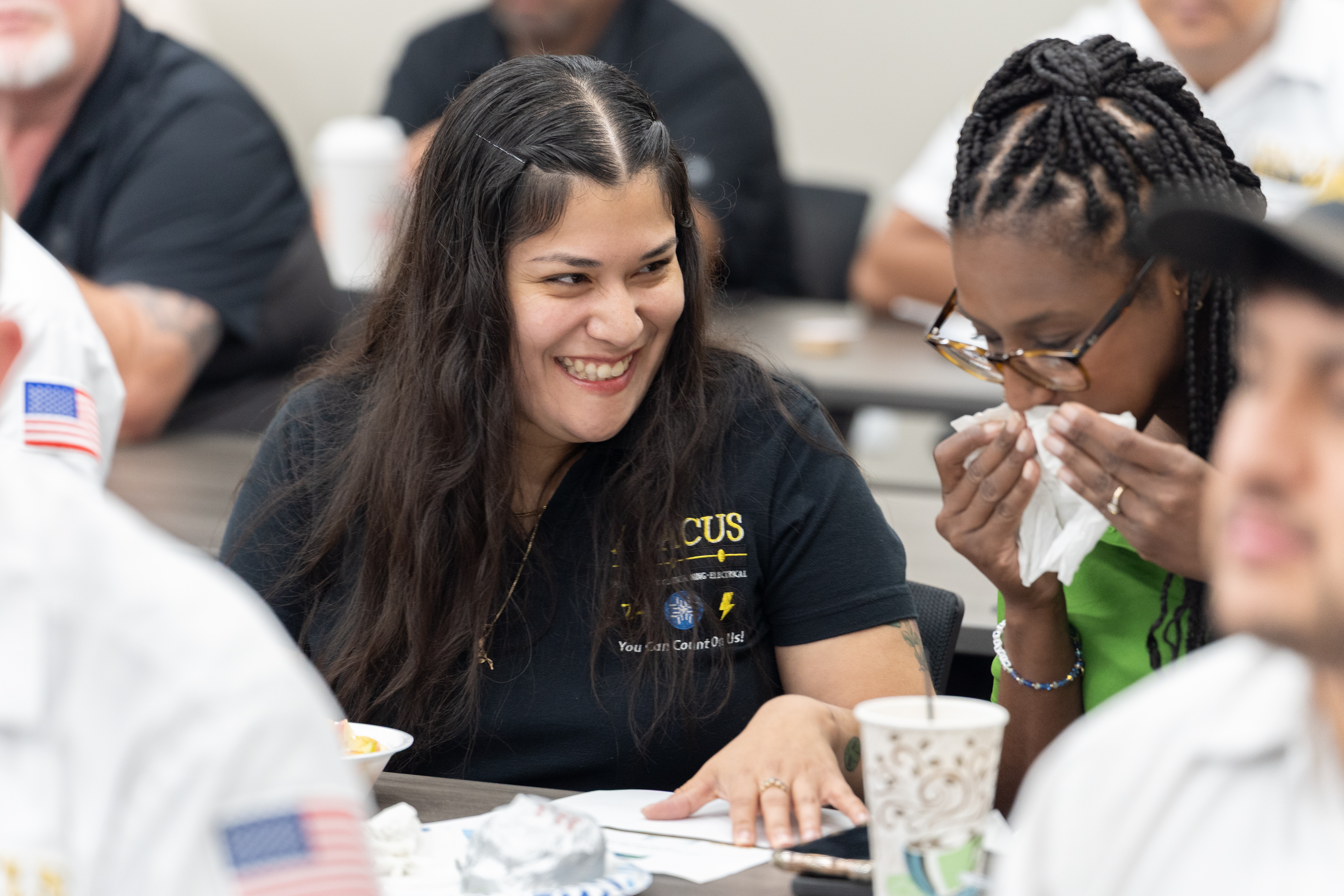 Smiling team members share a moment during training, showcasing the friendly, professional culture at Abacus Plumbing, Air Conditioning, & Electrical.