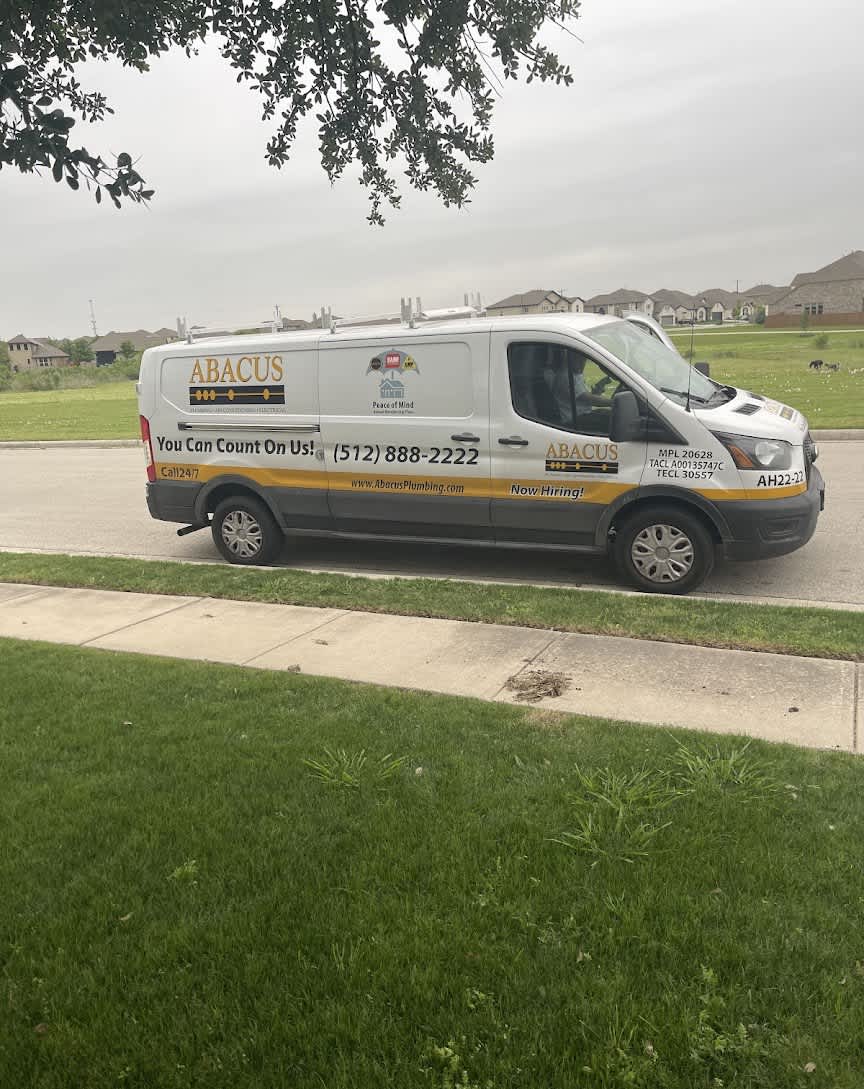 A clean, clearly branded Abacus Plumbing, Air Conditioning, & Electrical service van parked in a neighborhood communicates reliability and prompt local service.