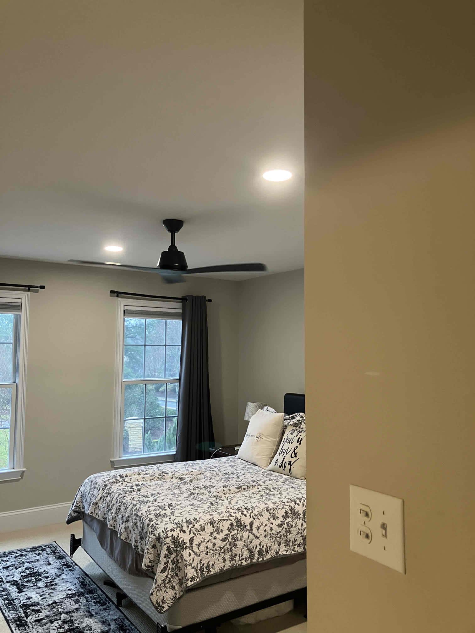 A neatly finished bedroom with reliable fixtures shows Dawson's Electric & Air delivering professional, trustworthy home comfort.