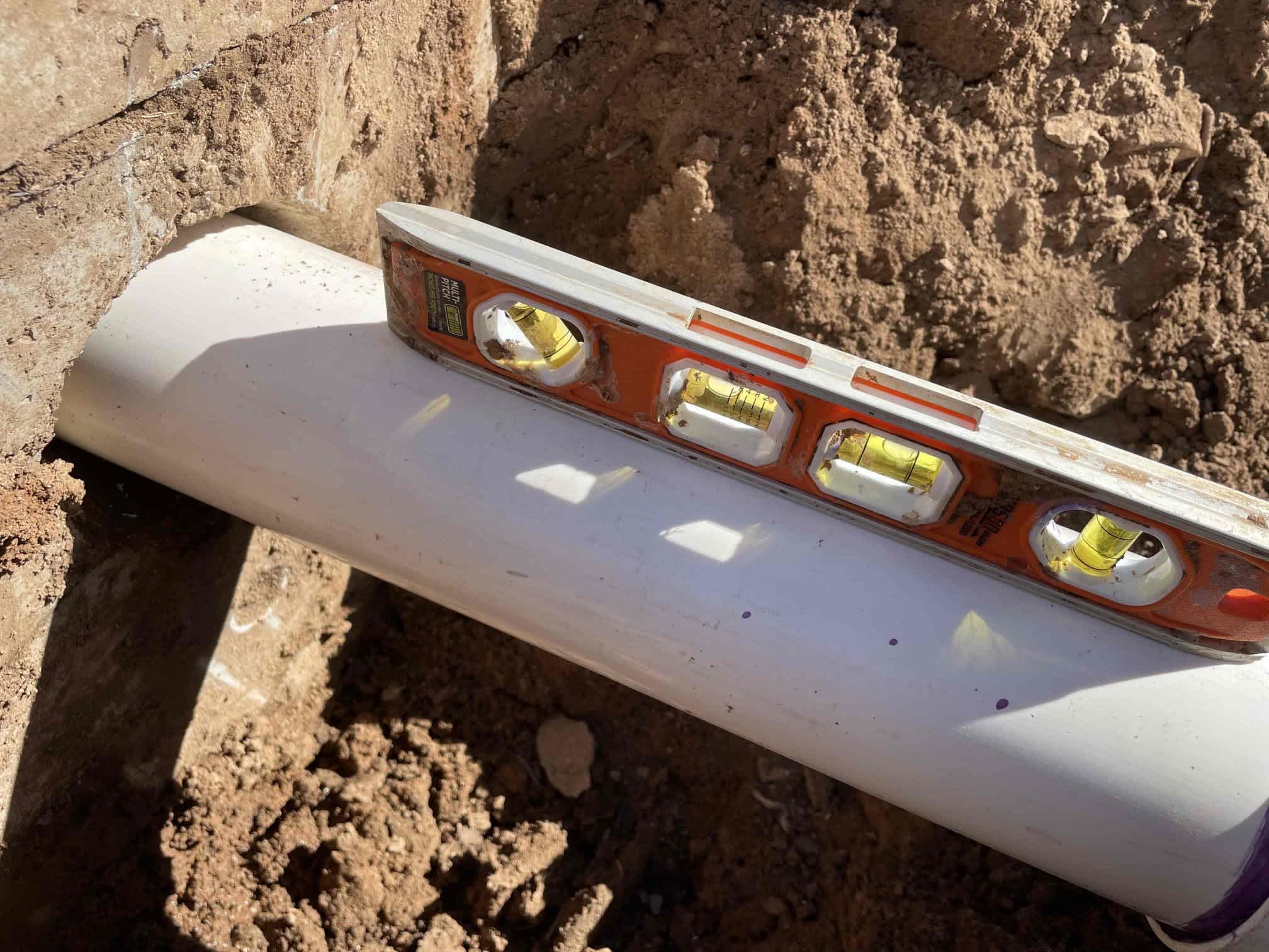 Parobek Plumbing & Air Conditioning ensures precision and quality in every pipe installation, as seen in their meticulous leveling process.