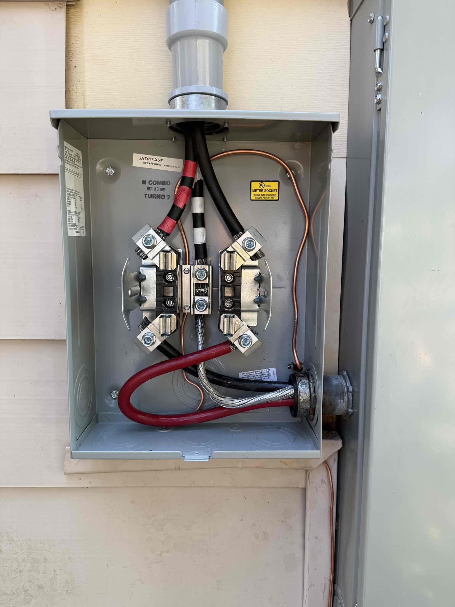 Clean, code-focused electrical service work shows the care Dawson's Electric & Air brings to every outdoor meter and connection.