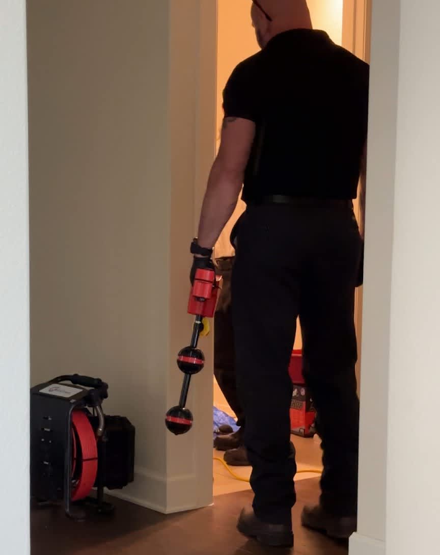 A focused technician from Abacus Plumbing, Air Conditioning, & Electrical arrives with specialized tools to resolve your home's drain or plumbing issue confidently.