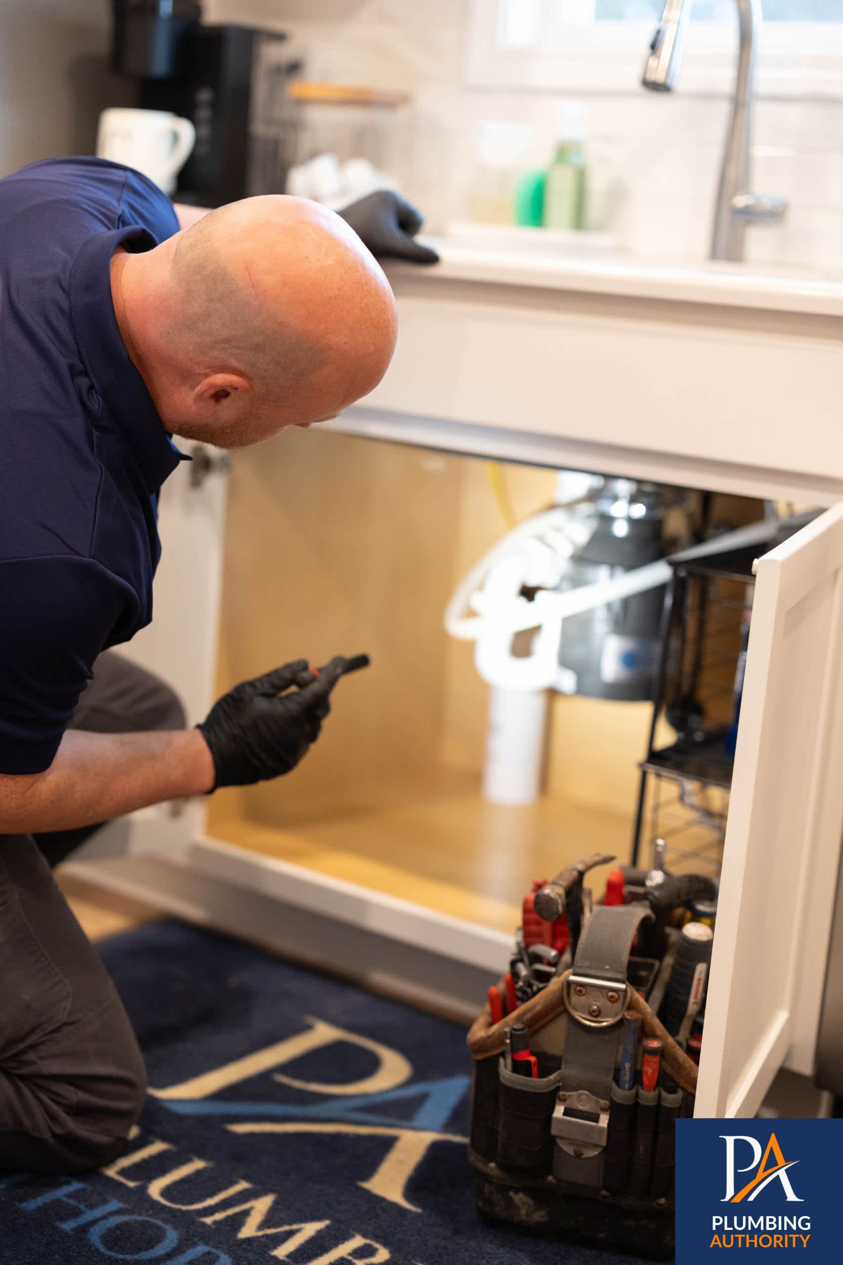 A skilled technician from The Plumbing Authority carefully inspects your under‑sink plumbing, delivering clean, reliable service you can trust.