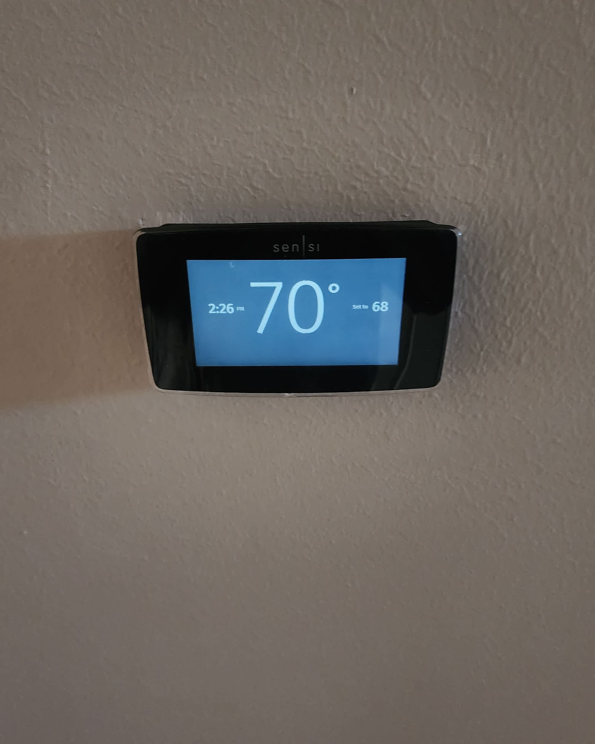 A precise thermostat installation highlights reliable comfort control and clean workmanship by Abacus Plumbing, Air Conditioning & Electrical.