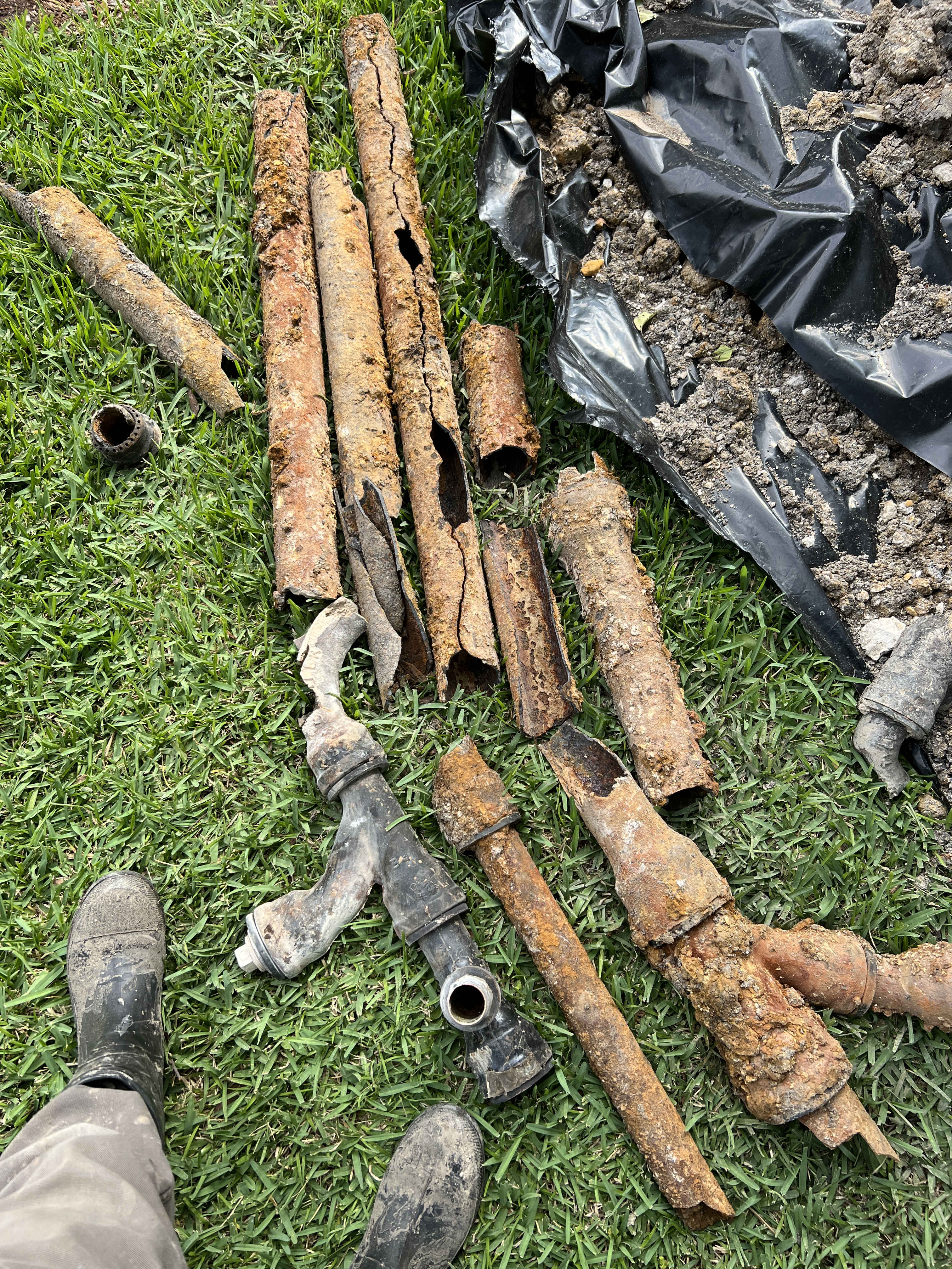 Showing clear before and after results, Rise Plumbing Systems replaces heavily corroded underground pipes to restore reliable water flow.