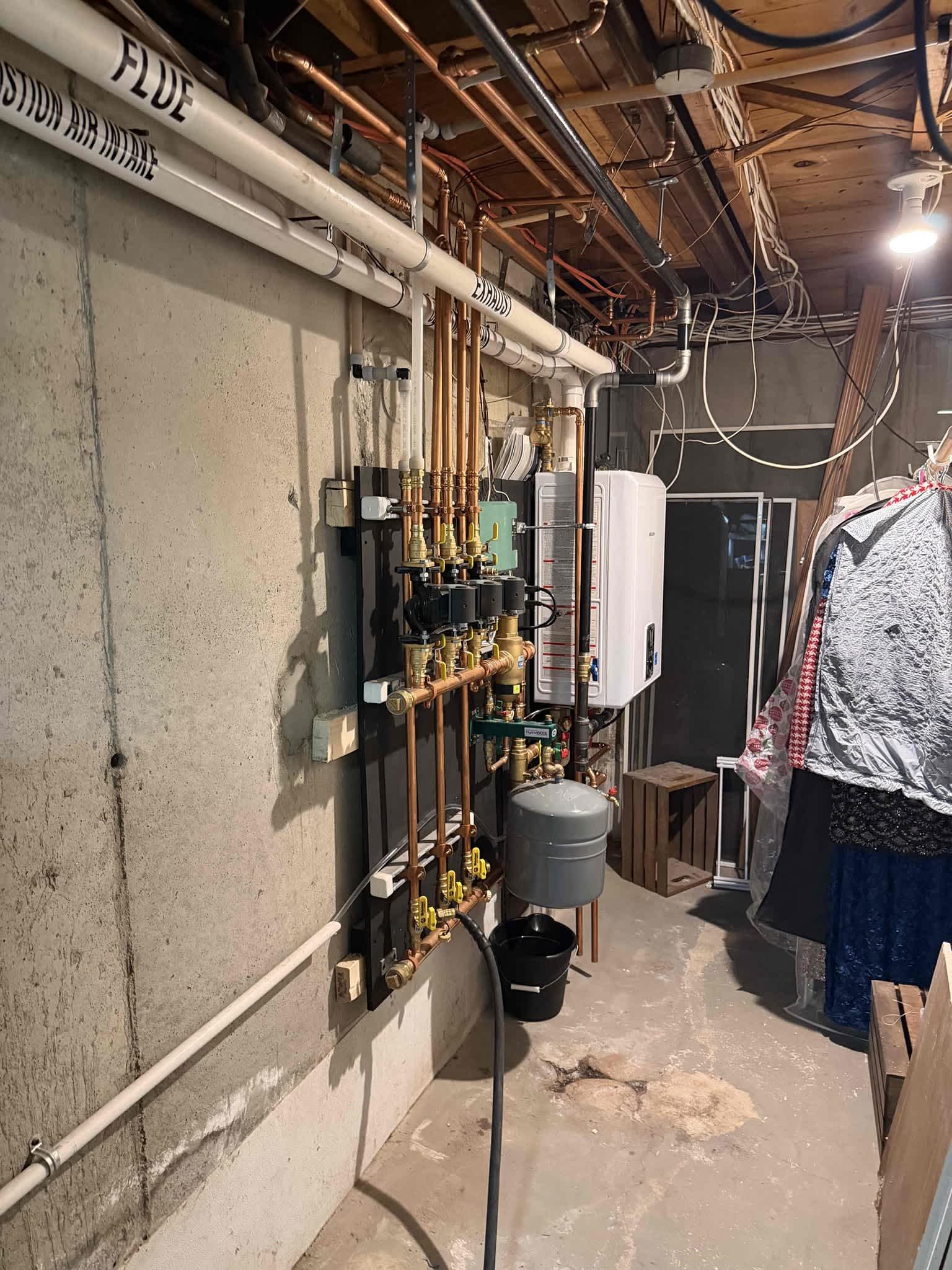 Akian Plumbing, Heating, Cooling & Electric demonstrates precise, tidy installation of a tankless water system that boosts efficiency and reliability.