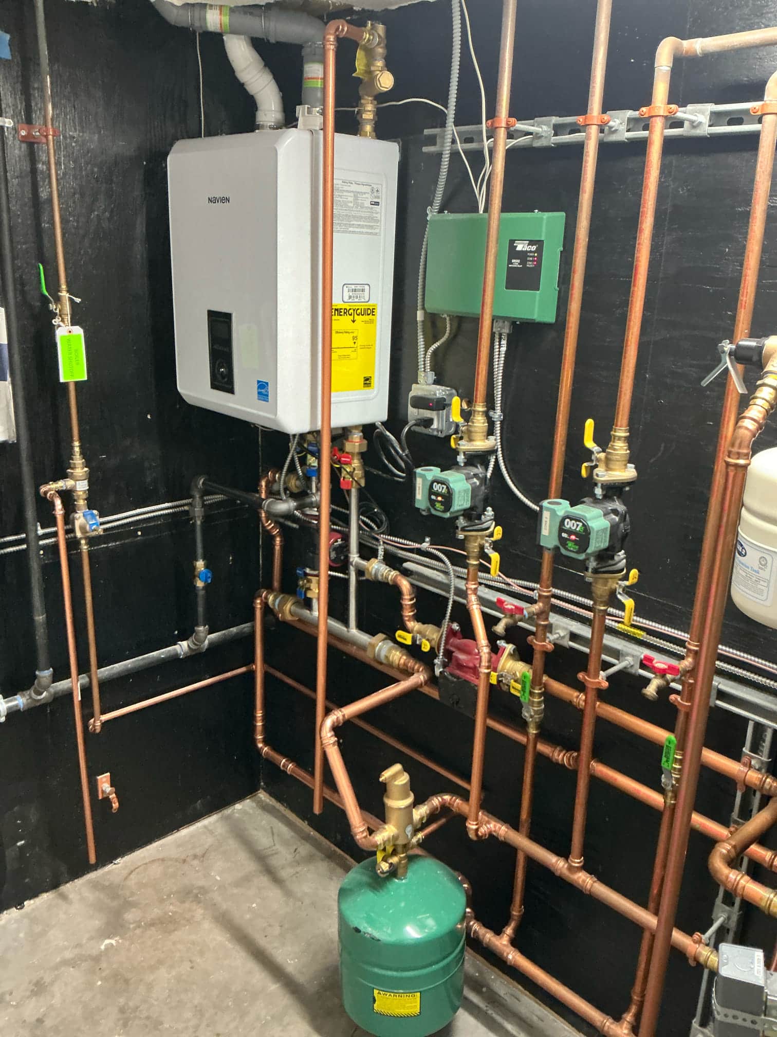 Akian Plumbing, Heating, Cooling & Electric showcases its expertise with a precisely installed tankless water heater system, reflecting a commitment to excellence and modern efficiency.